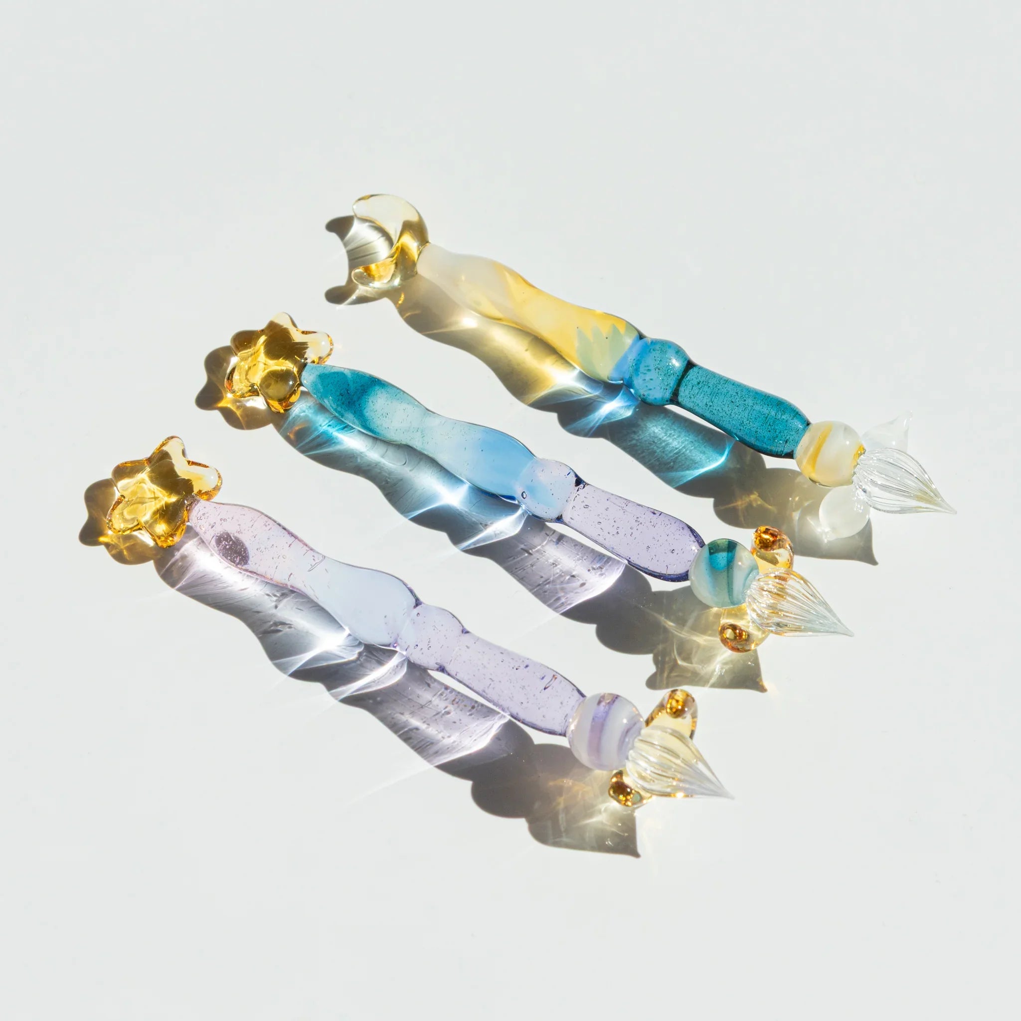 Lunar Glow glass dip pen set with pale yellow iridescent barrel and matching turquoise-colored moon rest detail