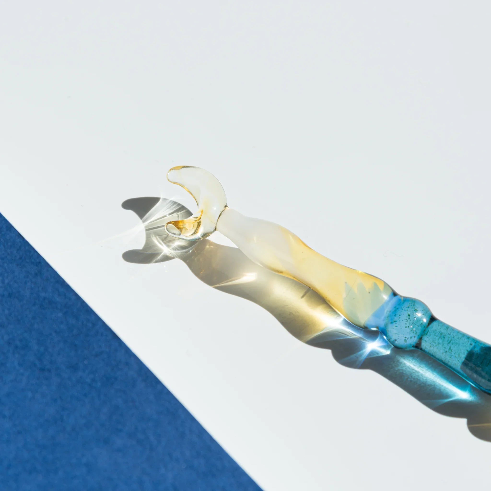 Lunar Glow Japanese glass dip pen featuring iridescent pale yellow opalescent finish and turquoise handle wrap