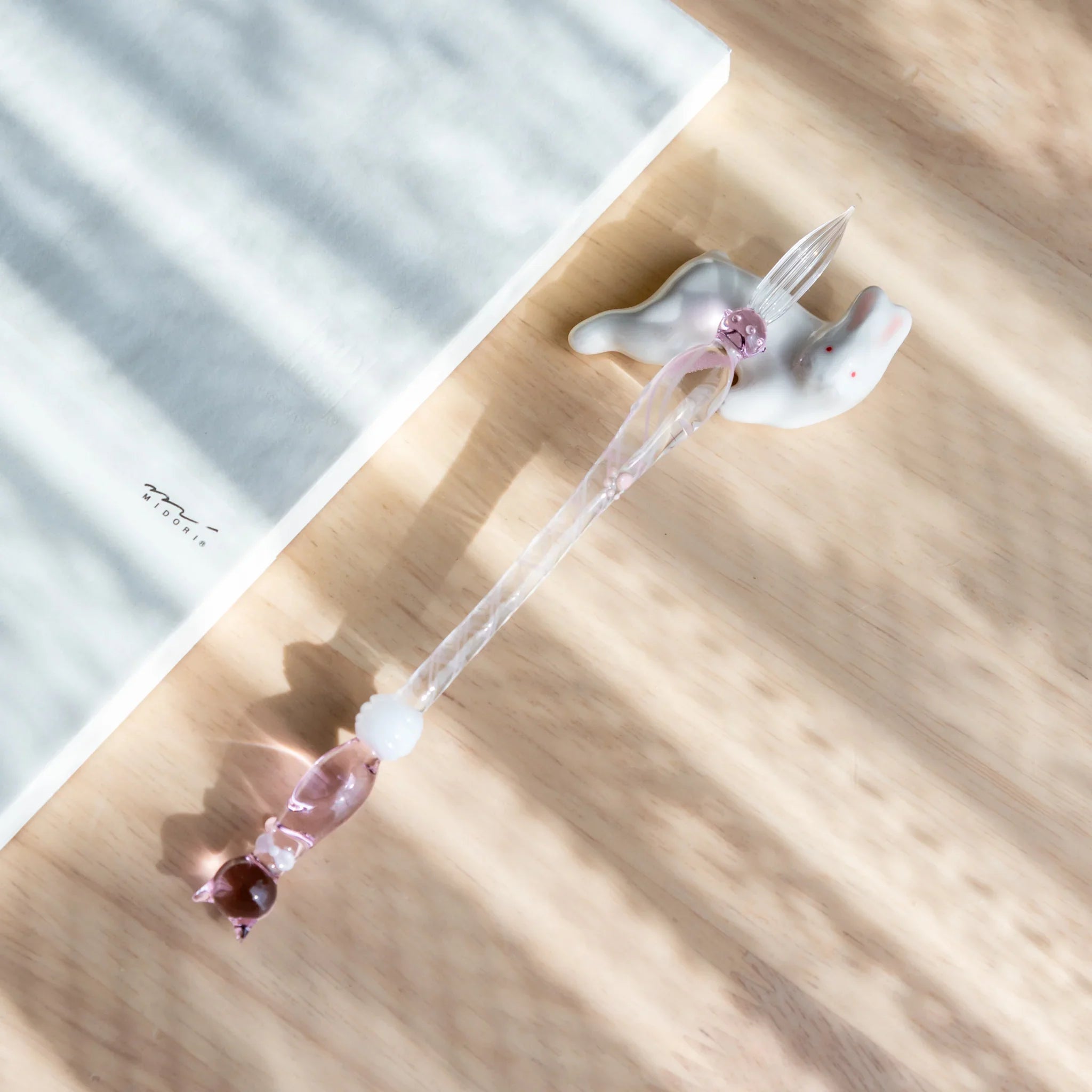 Lying rabbit ceramic pen rest gray Japanese handcrafted with neutral tone and relaxed animal pose form close shot