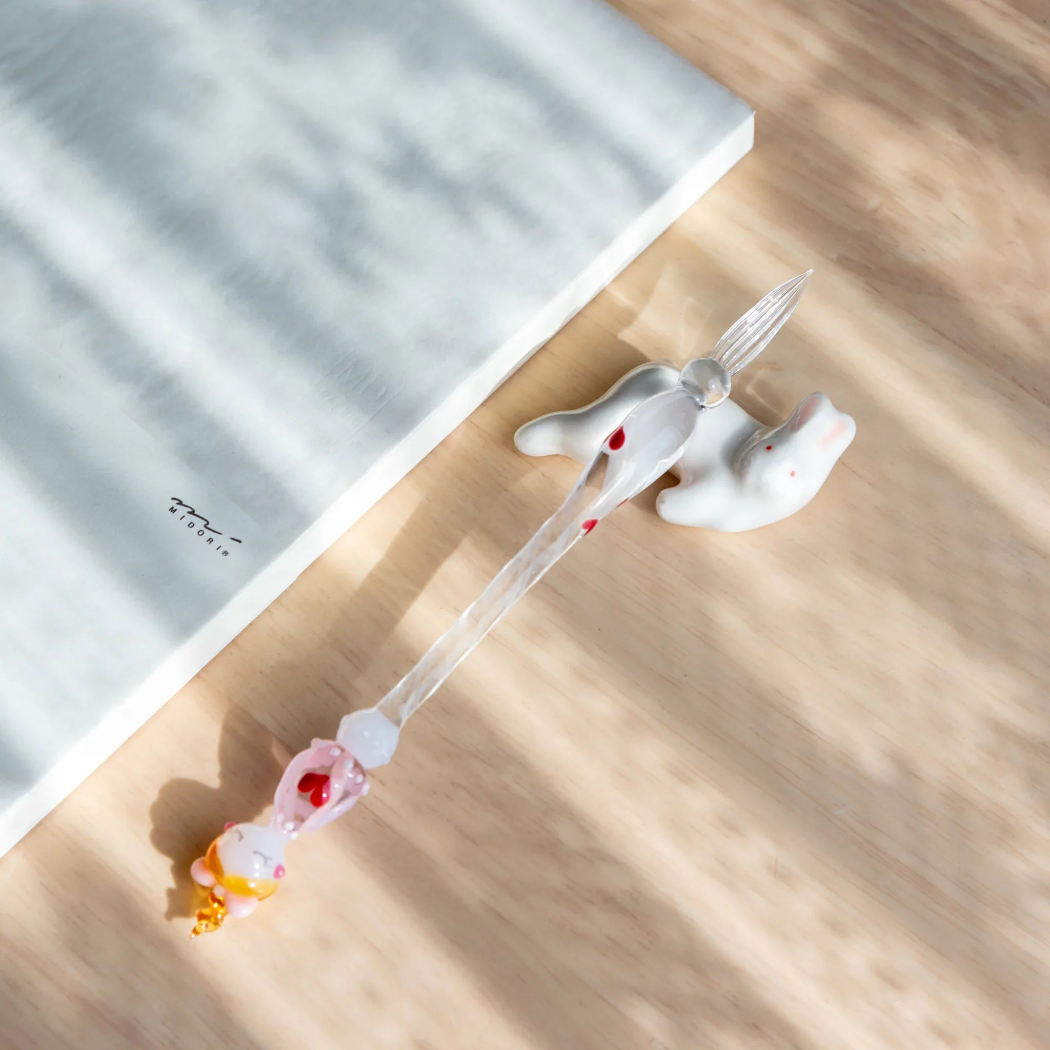 Lying rabbit ceramic pen rest soft gray handcrafted Japanese with peaceful animal design and fine detail close shot