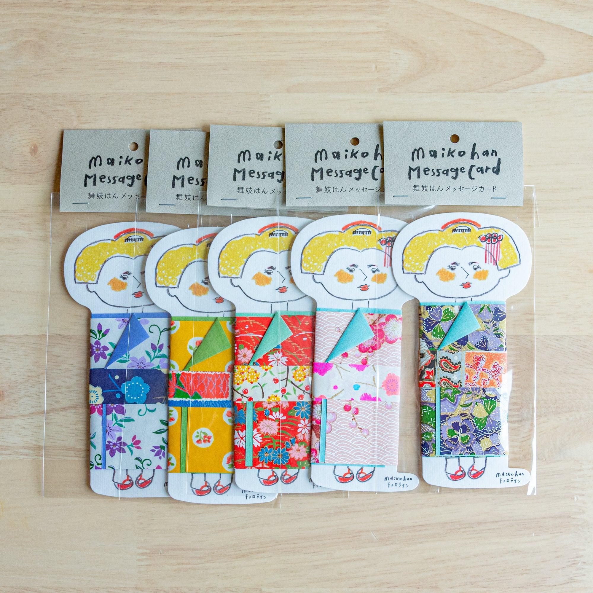 Five Maikohan Message Card packages on wood, each with a yellow-haired maiko figure in a different yuzen washi kimono