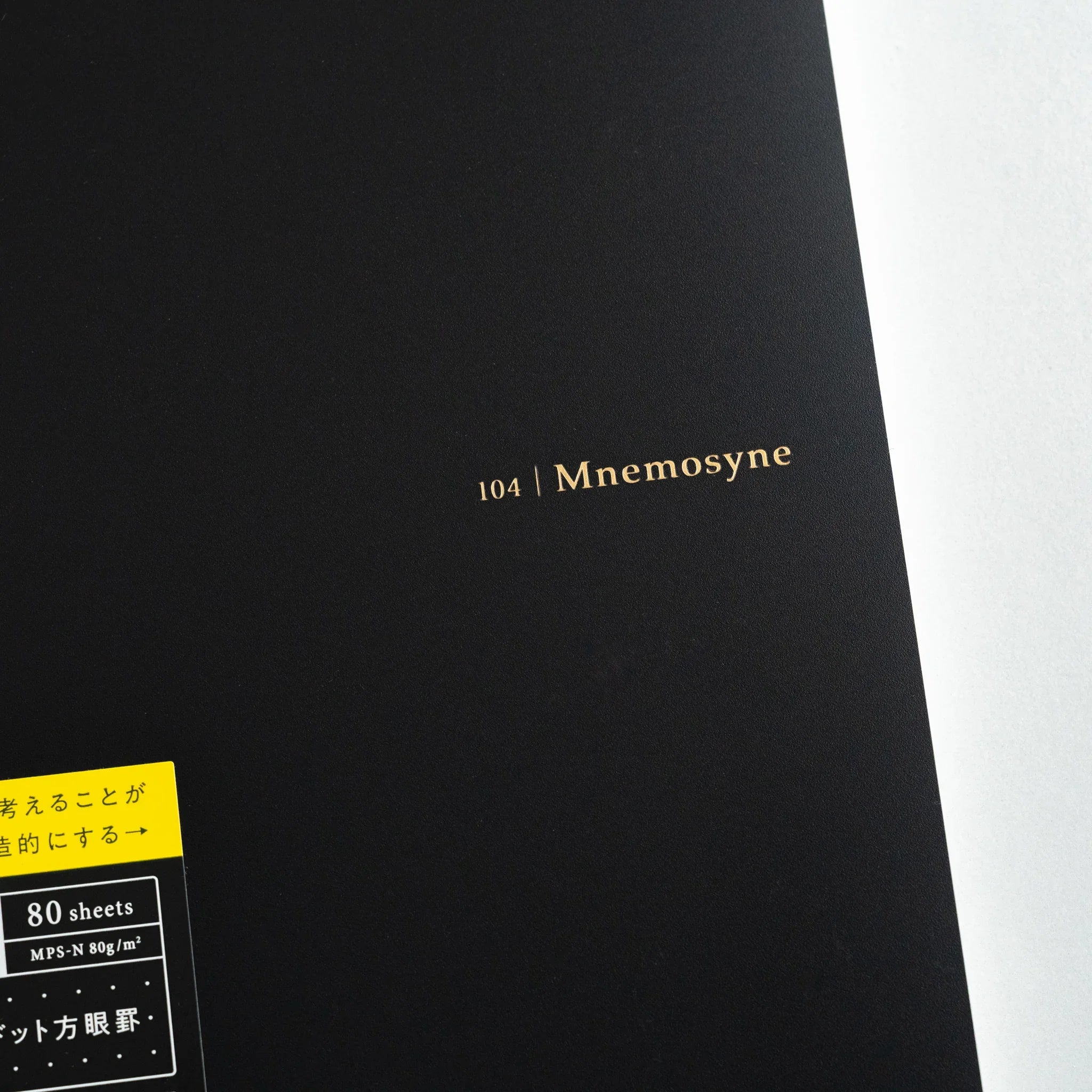 Maruman Mnemosyne notebook, flat lay showing closed white cover, Maruman Mnemosyne Japan A5 dot grid notepad with perforated