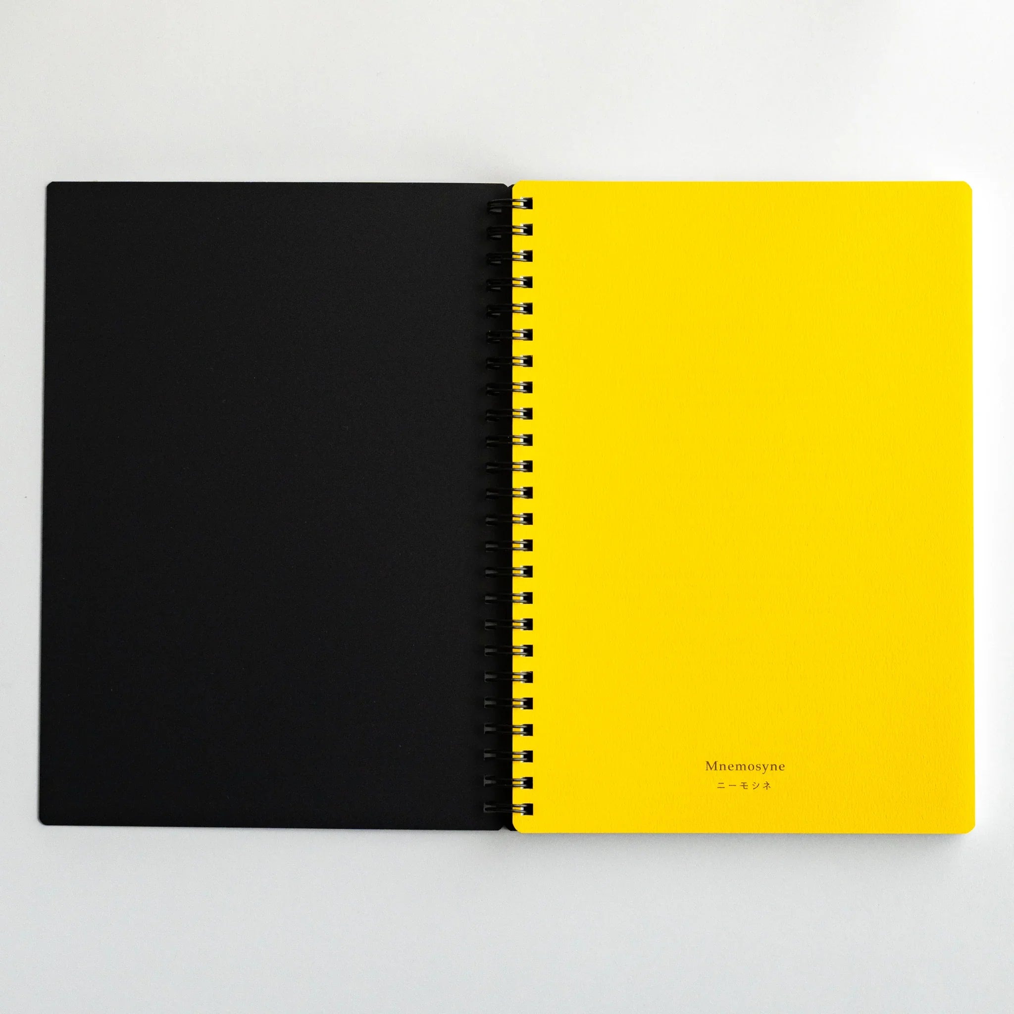 Maruman Mnemosyne notebook, cover flat lay showing minimalist white cover, A5 5mm dot grid Mnemosyne notebook by Maruman for