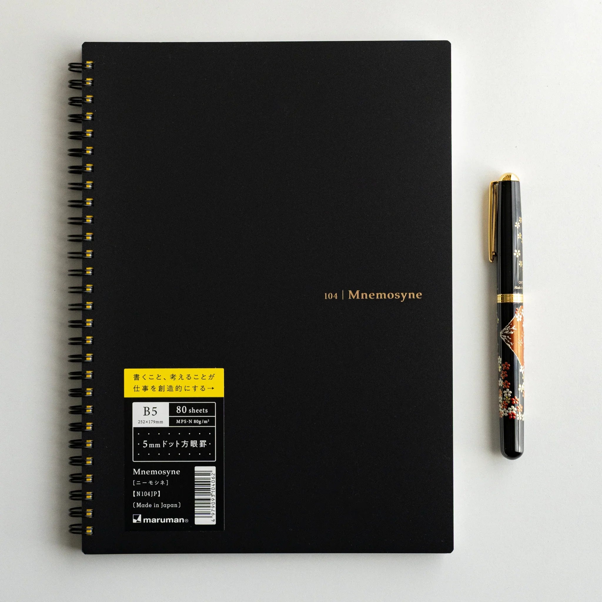 Maruman Mnemosyne notebook, angled composition highlighting dot grid, Maruman Mnemosyne Japan A5 dot grid notepad with