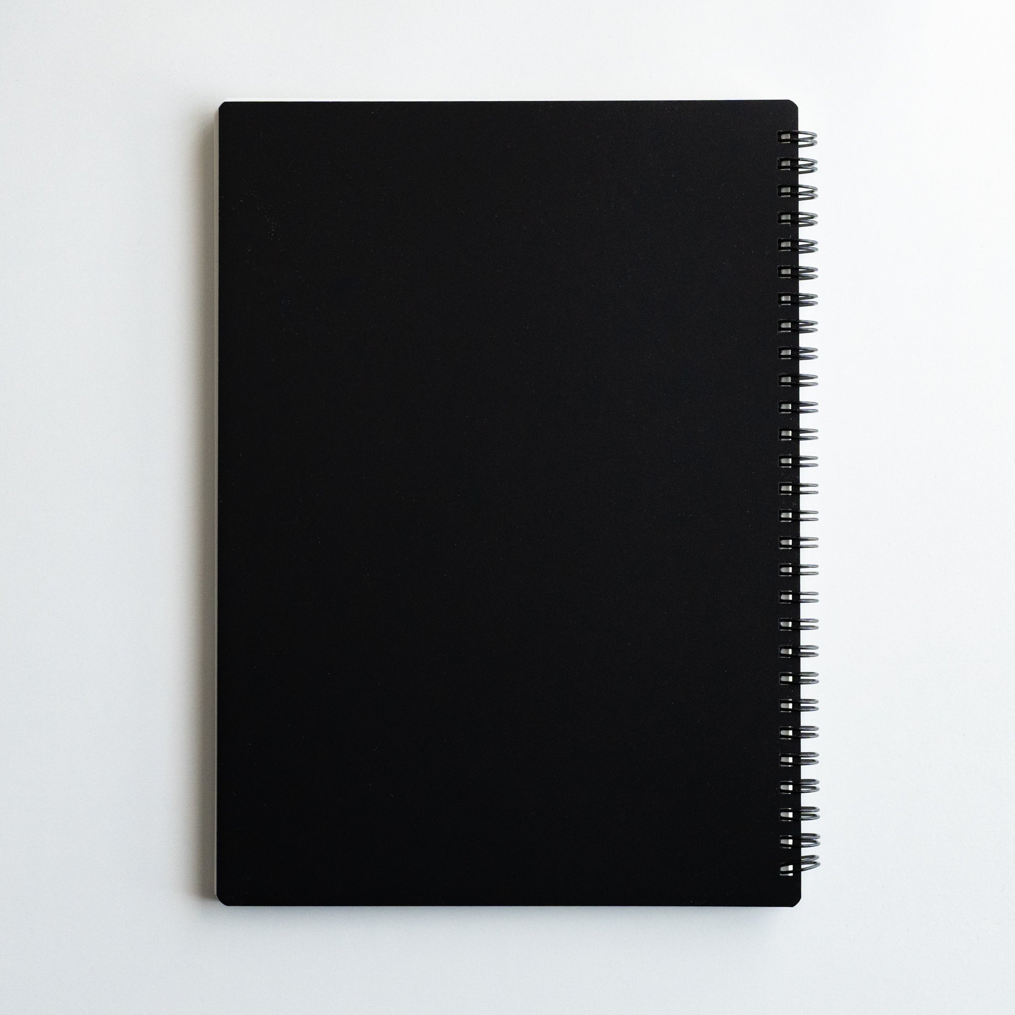 Maruman Mnemosyne 8 mm lined notebook with sleek black cover and coil binding, minimalist Japanese stationery