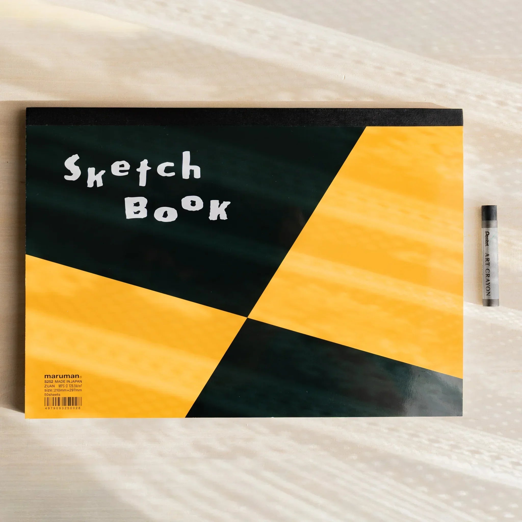 Maruman Japanese sketchbook with black and orange geometric cover labeled Sketch Book.