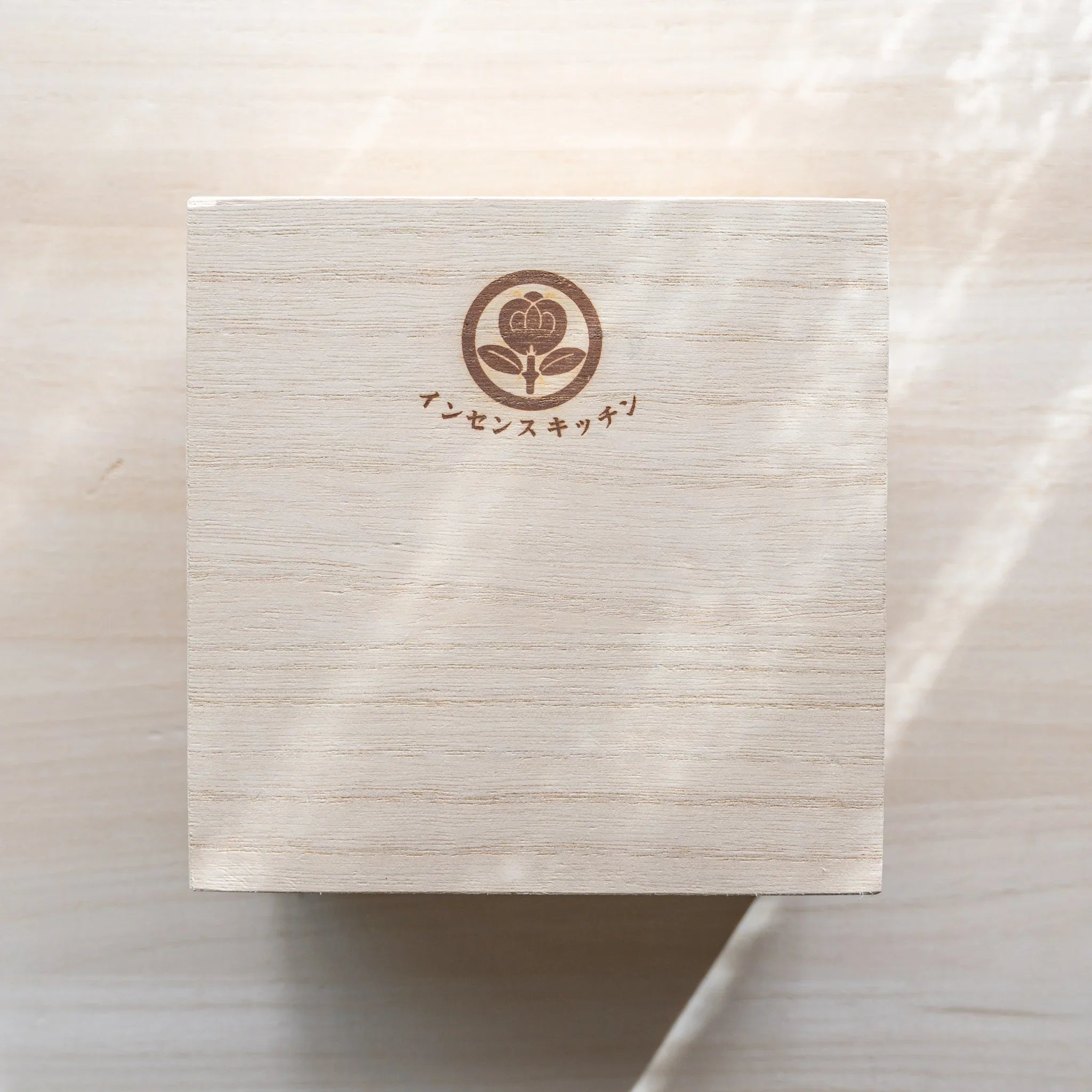 Top-down view of paulownia wood gift box with INCENSE KITCHEN logo for Suruga bamboo matcha incense warmer