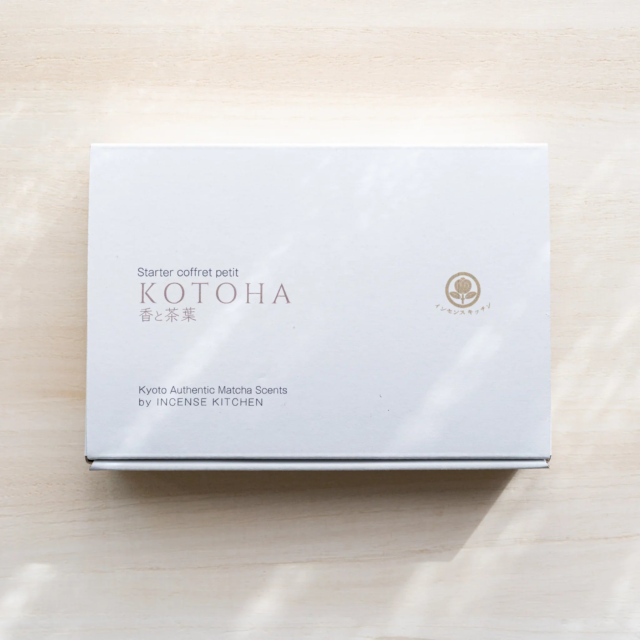 Paper packaging box for INCENSE KITCHEN matcha incense tea warmer starter set on a light wood surface