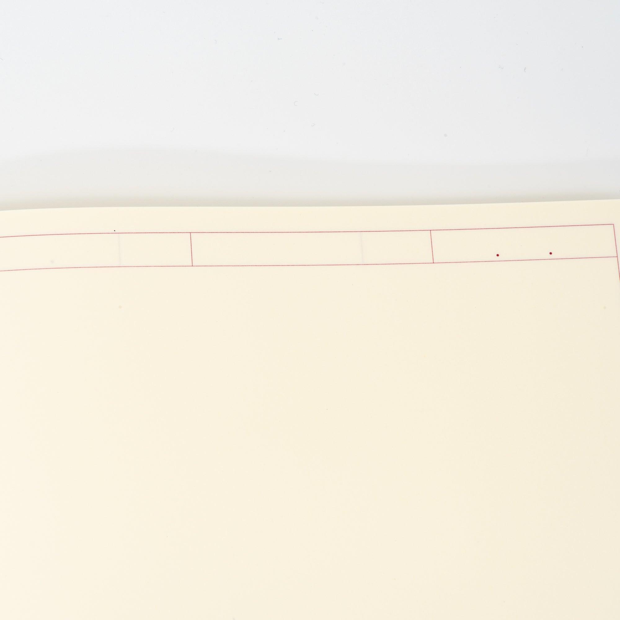 Close-up of an MD notebook's red frame detail, showcasing precise craftsmanship in Japanese stationery.