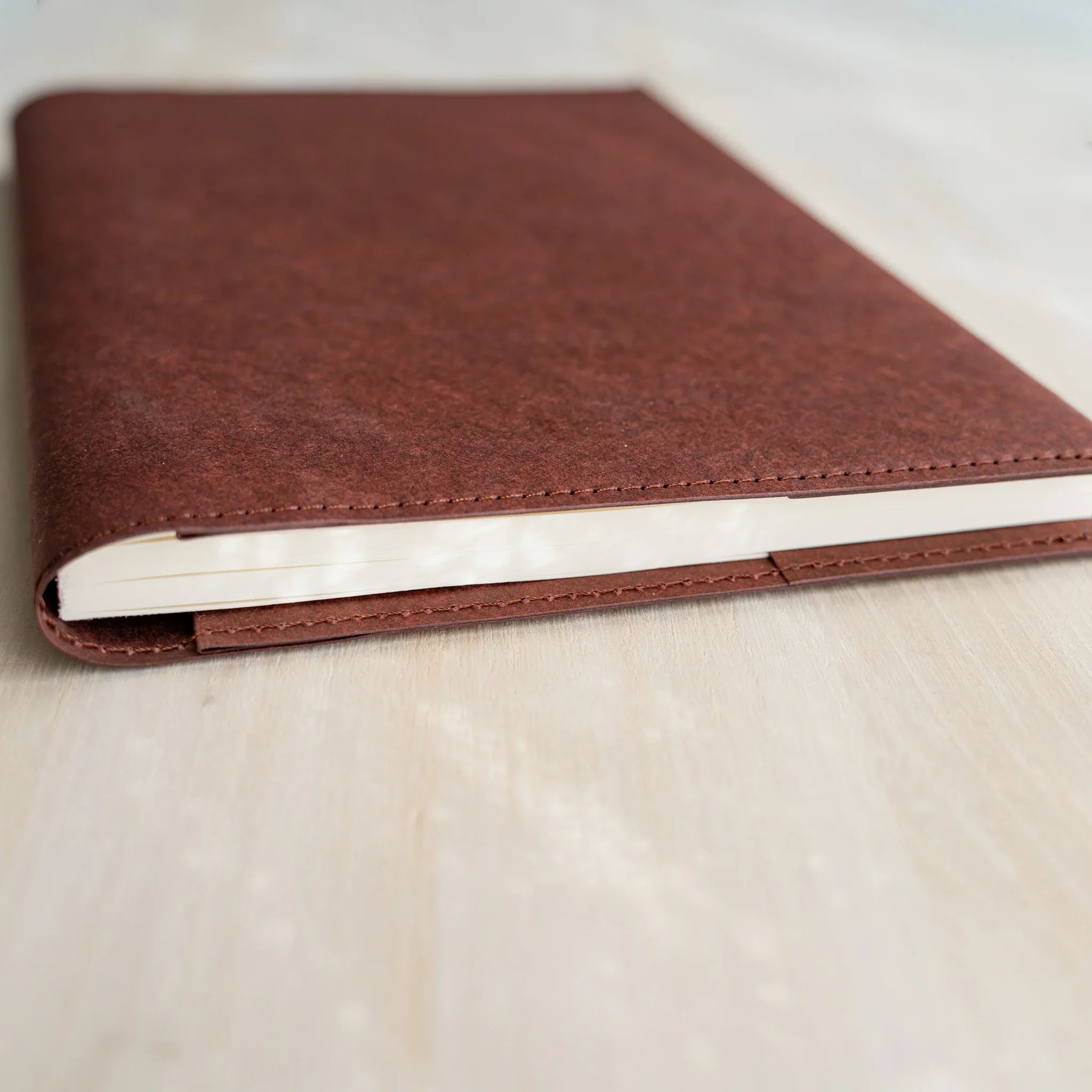 Midori MD Notebook Hard Cover side view with notebook inserted, dark red hard paper top and bottom, white pages visible