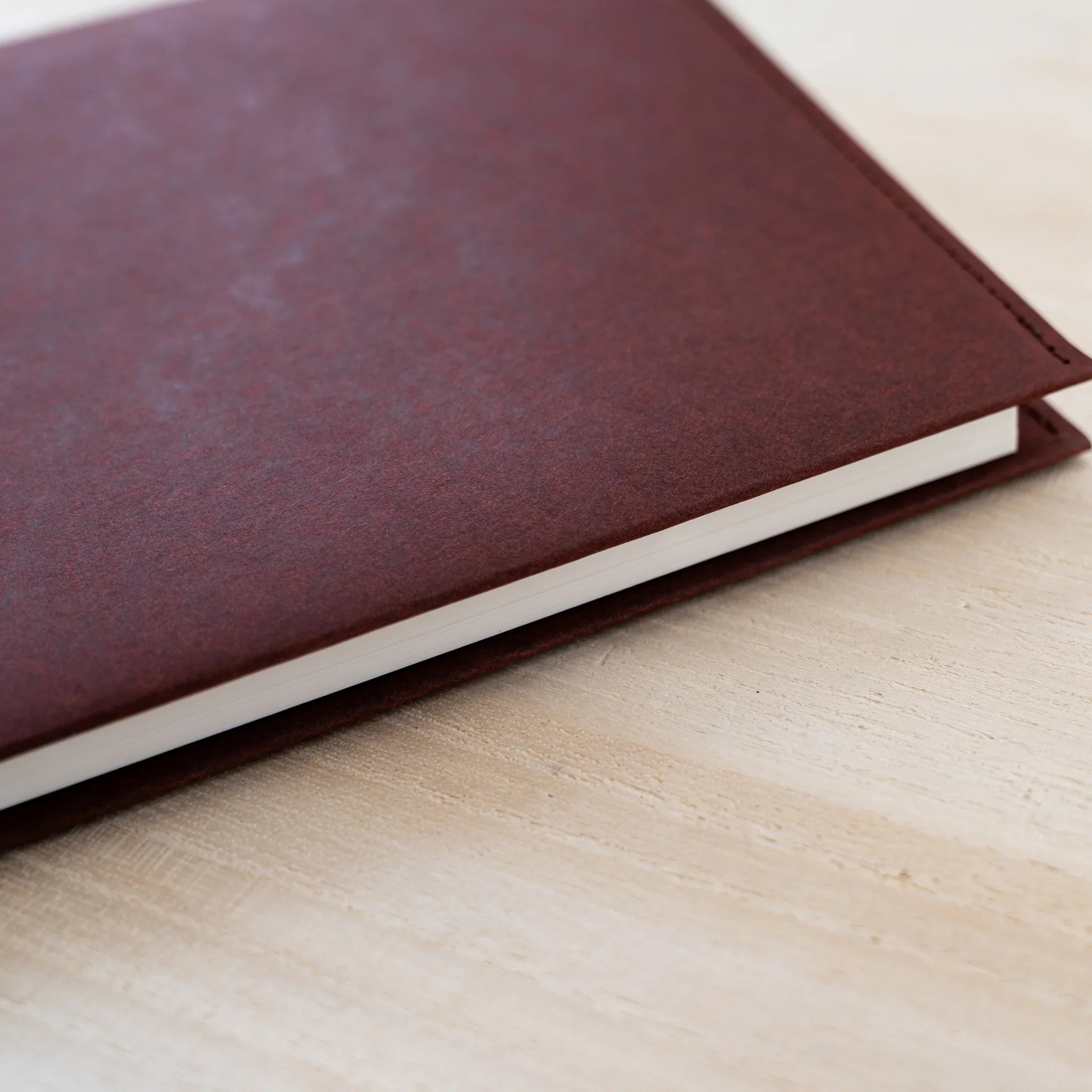 Close-up of the dark maroon firm paper of the MD Notebook Hard Cover A5 Square with cream page edges