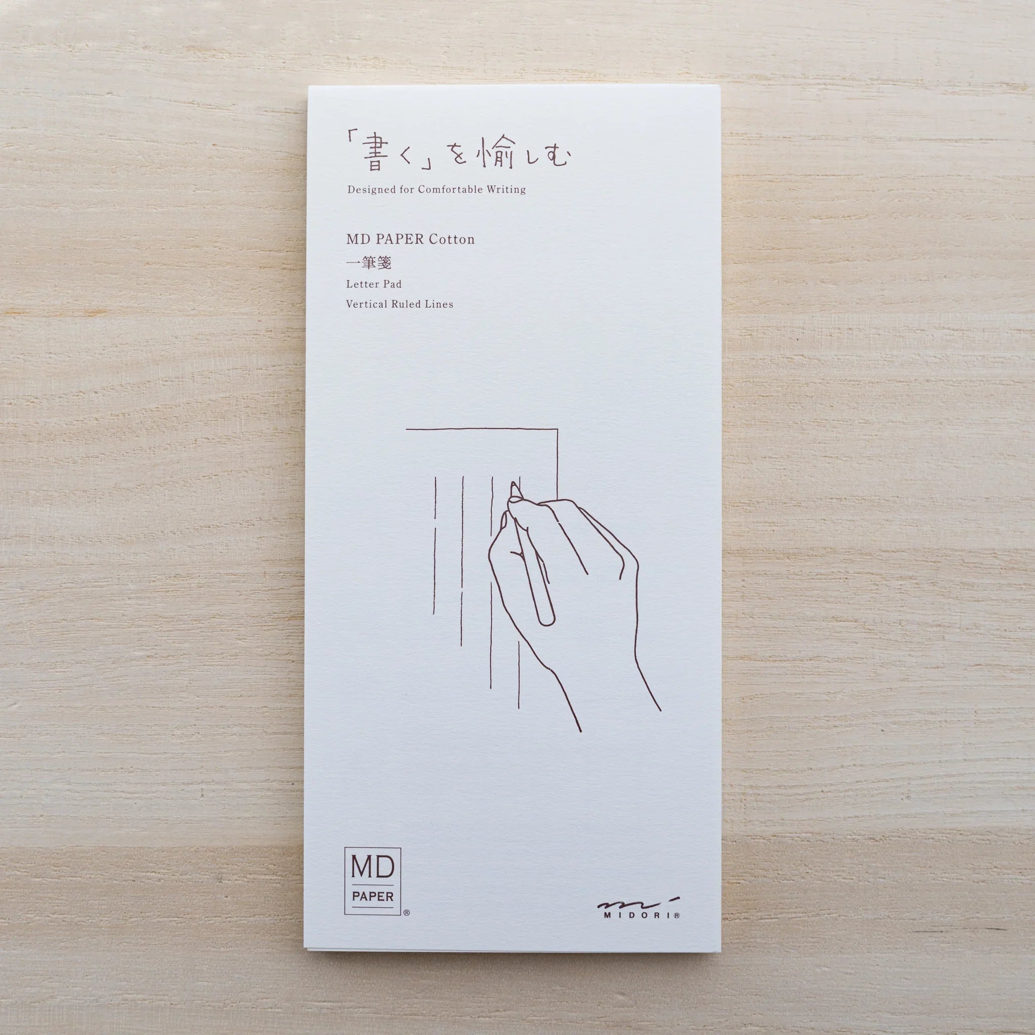 Front of an MD Paper Cotton letter pad cover with hand illustration reading MD Paper Cotton Letter Pad Vertical Ruled Lines