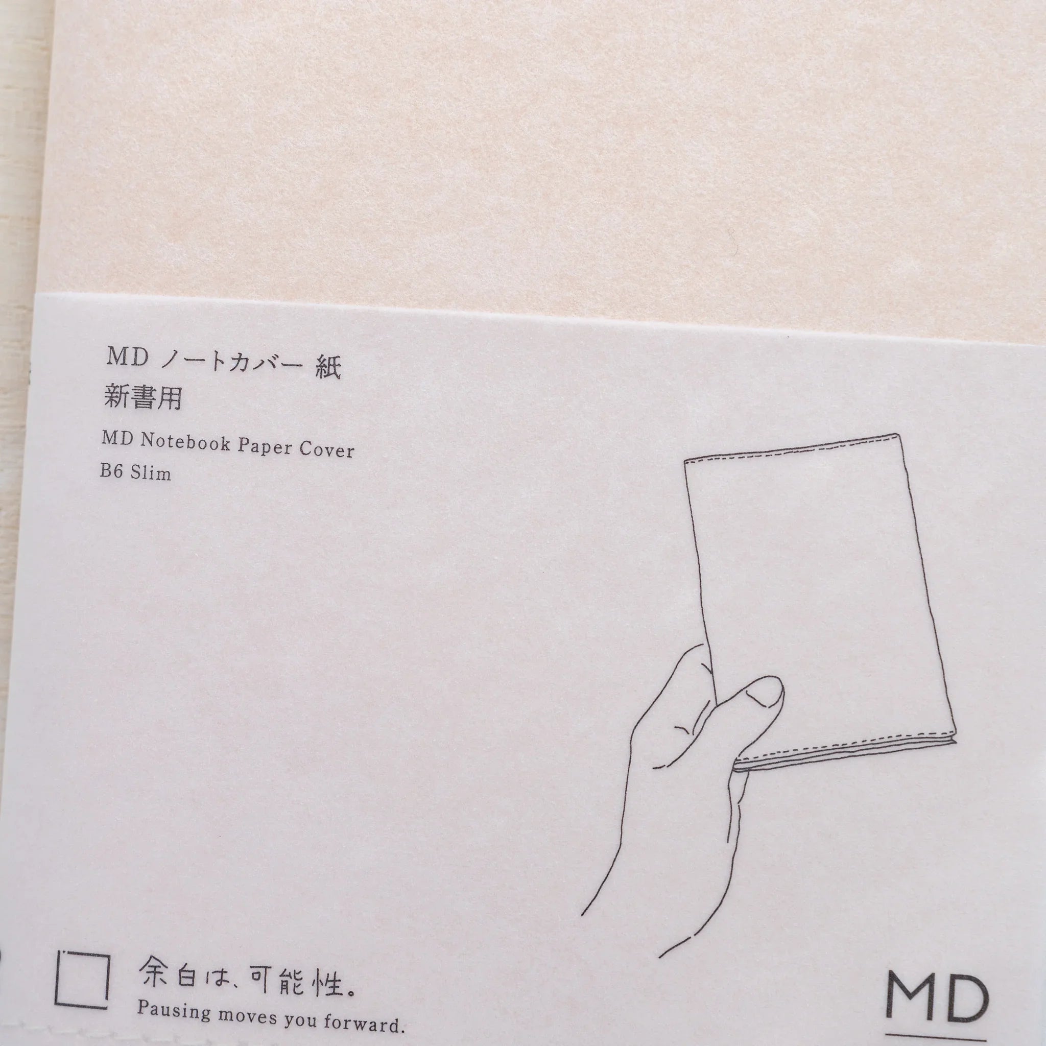 Close-up of MD Product Paper Notebook Cover packaging slip with Japanese and English product information.