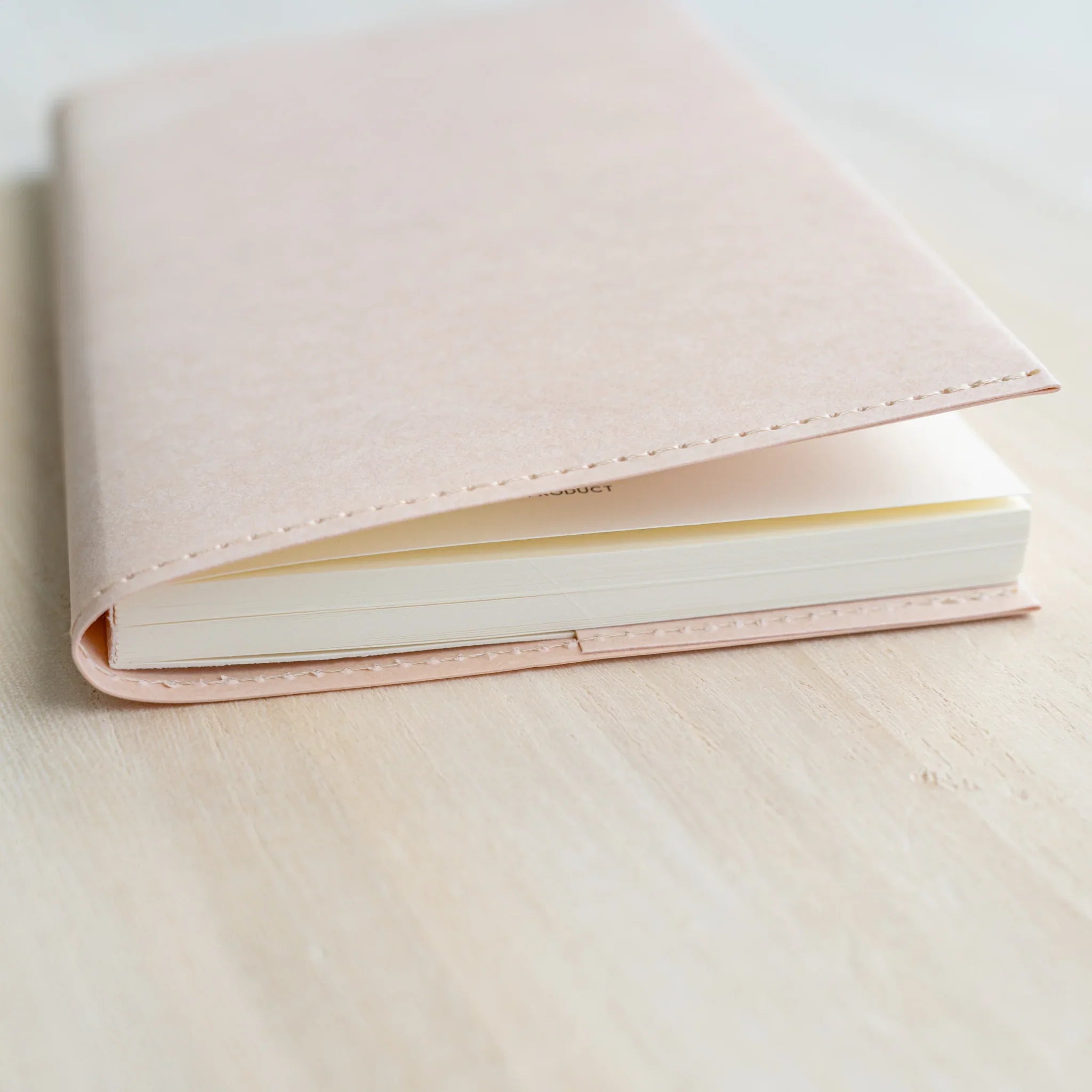 Side angle of MD Product Paper Notebook Cover B6 Slim with a Midori MD Paper notebook inserted.
