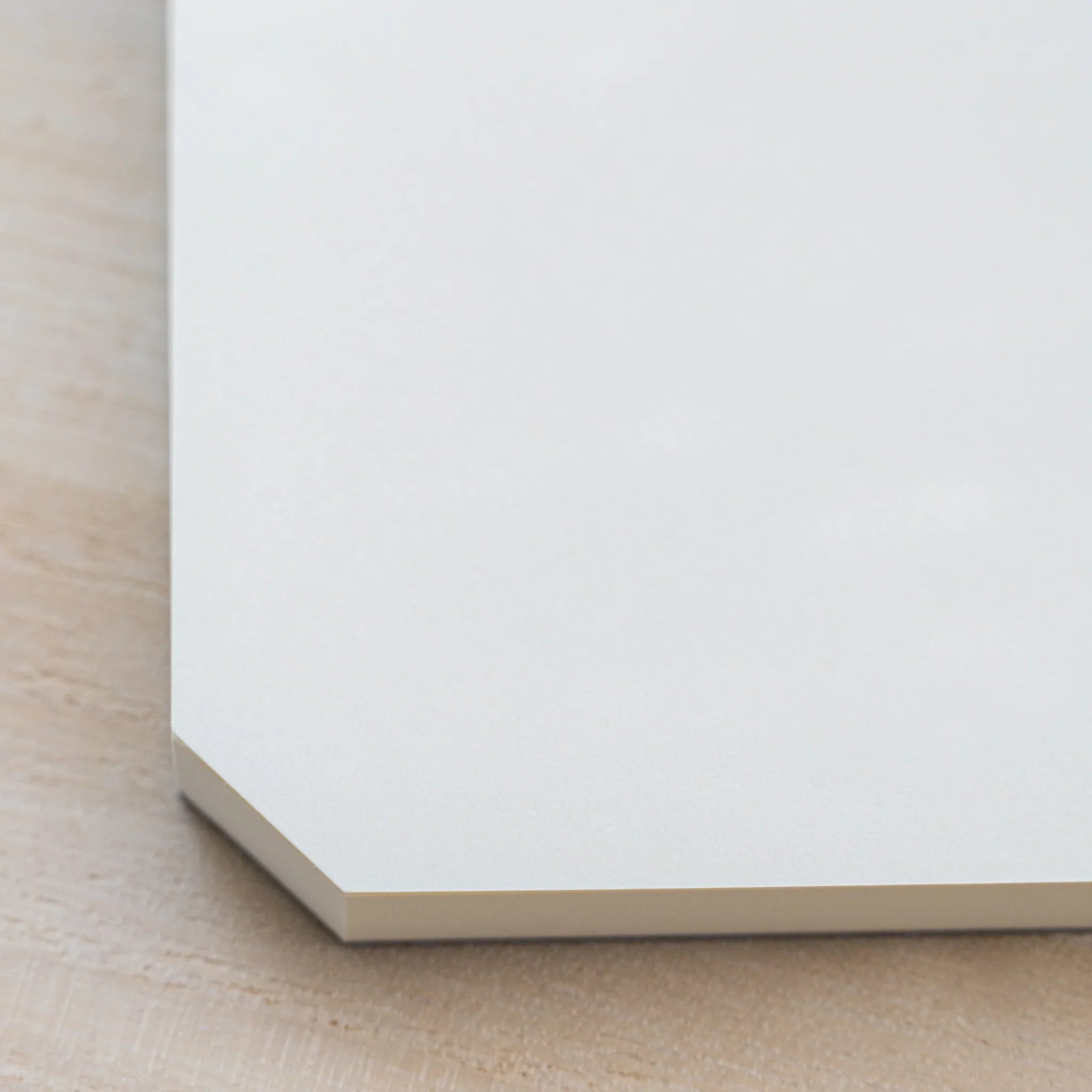 Close-up of the angled cut corner of a Midori MD Paper Pad A5 with cream page-block edge