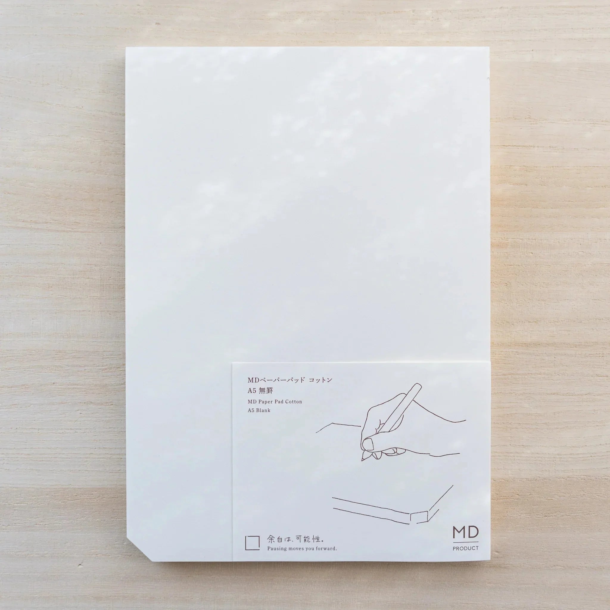 Midori MD Paper Pad Cotton A5, white top sheet with paper belly band reading MD Paper Pad Cotton A5 Blank and hand drawing