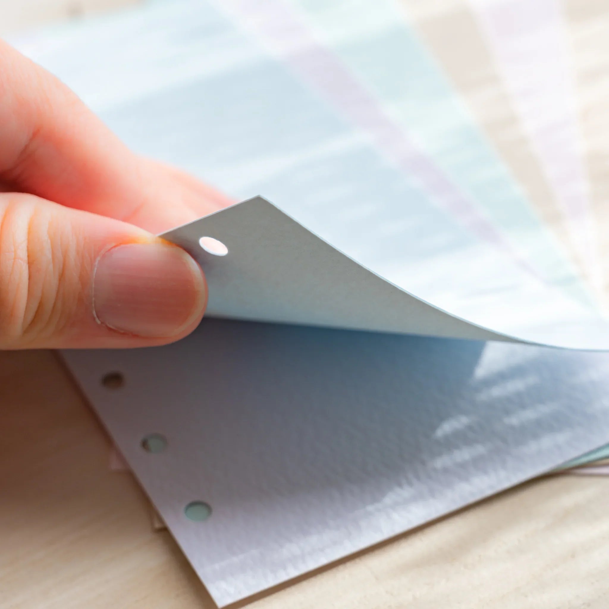 Japanese Stationery Mermaid top-tab index dividers for Bible size planners with pastel sheet being flipped by hand.