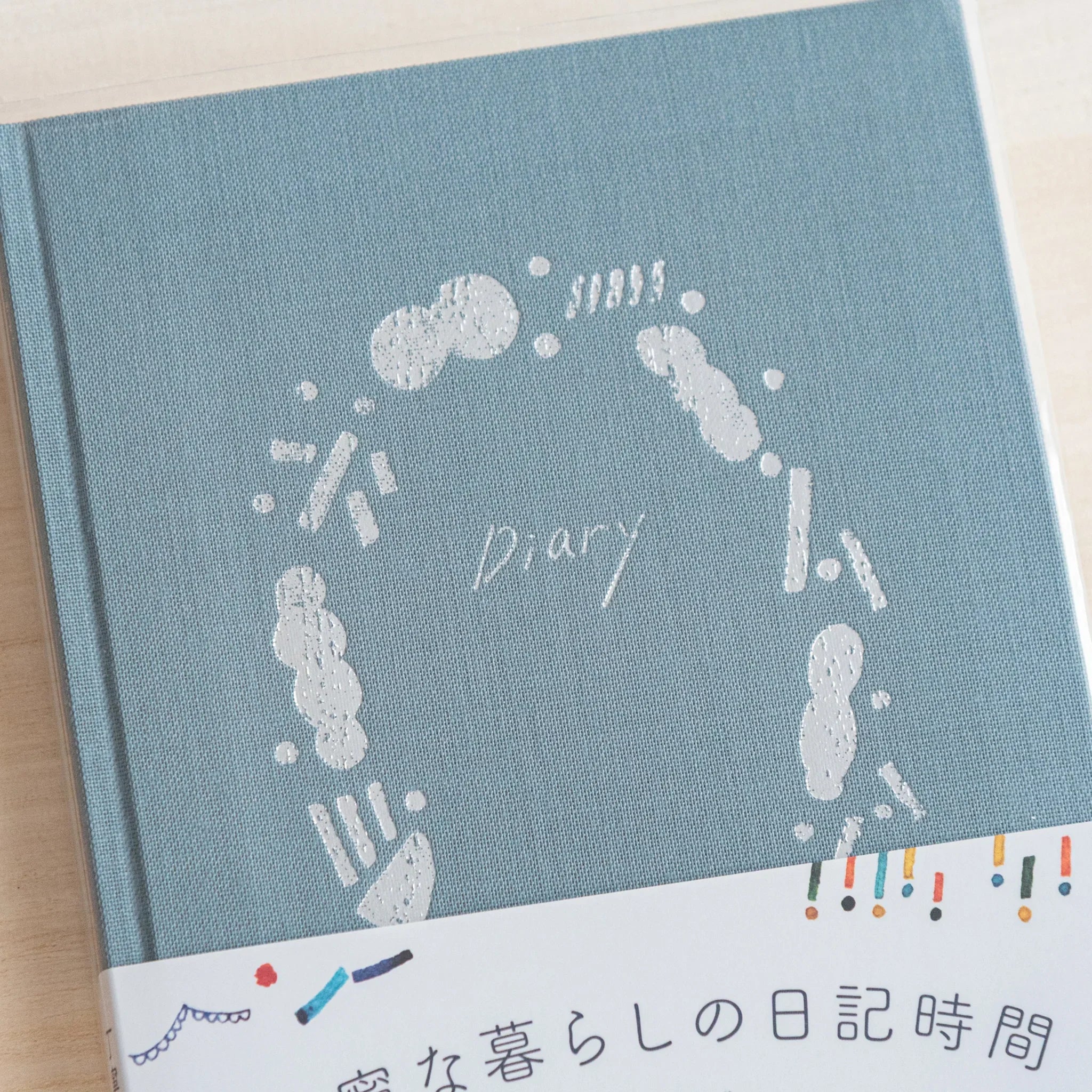 Close-up of Midori Japanese journal cover showing outing design with white circle motifs and paper band.