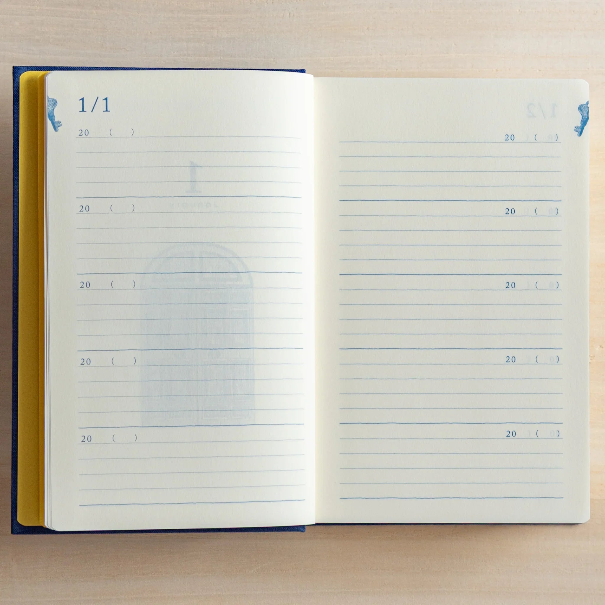 Open Midori Japanese journal 10-year diary gate design showing January 1 lined pages with faint door illustration.