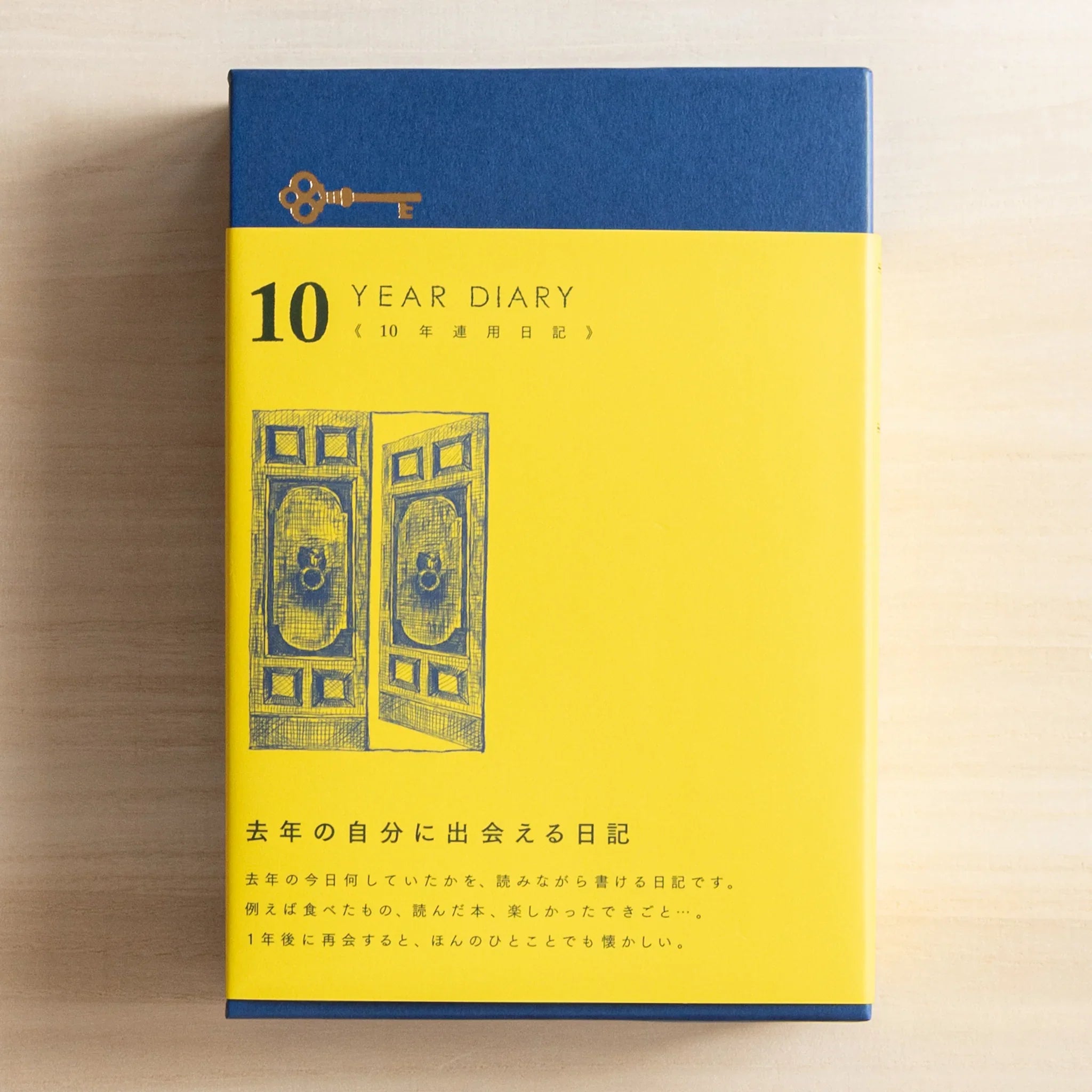 Midori 10-year journal, open spread showing cream interior pages with date headers, Japanese stationery product with quality