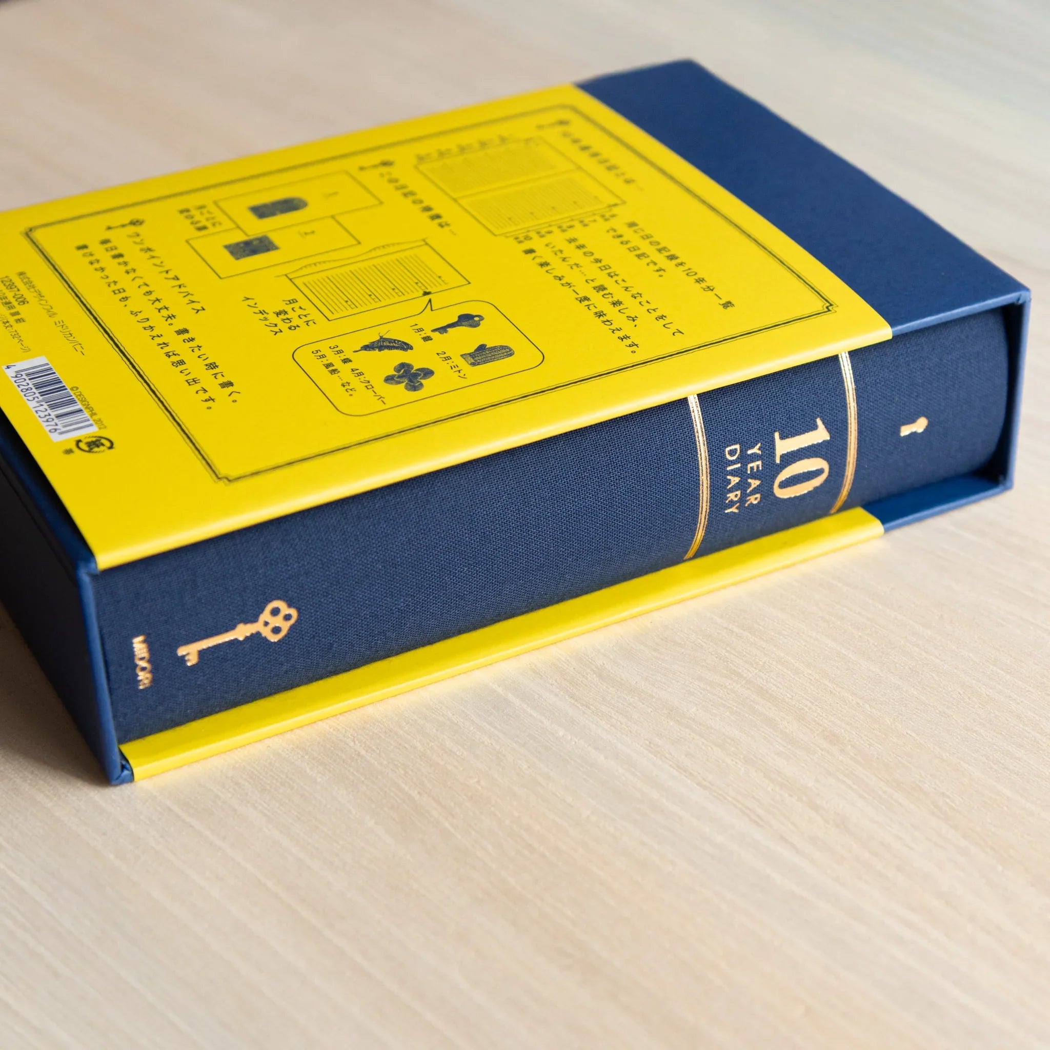 Midori 10-year journal, flat lay showing closed cover with gate design and binding, Japanese stationery product with quality