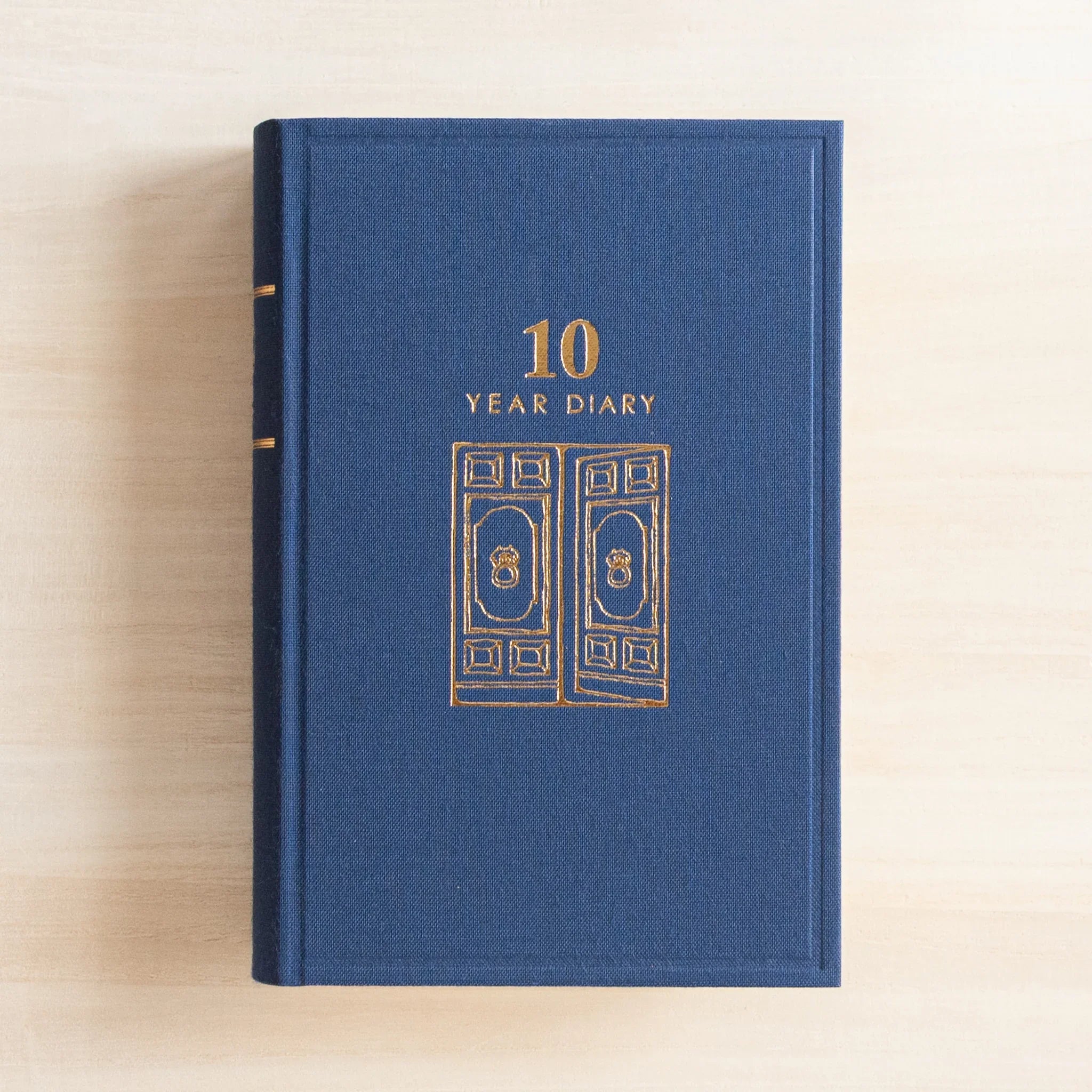 Midori 10-year journal, angled view showcasing cover gate embossing and construction, Japanese stationery product with