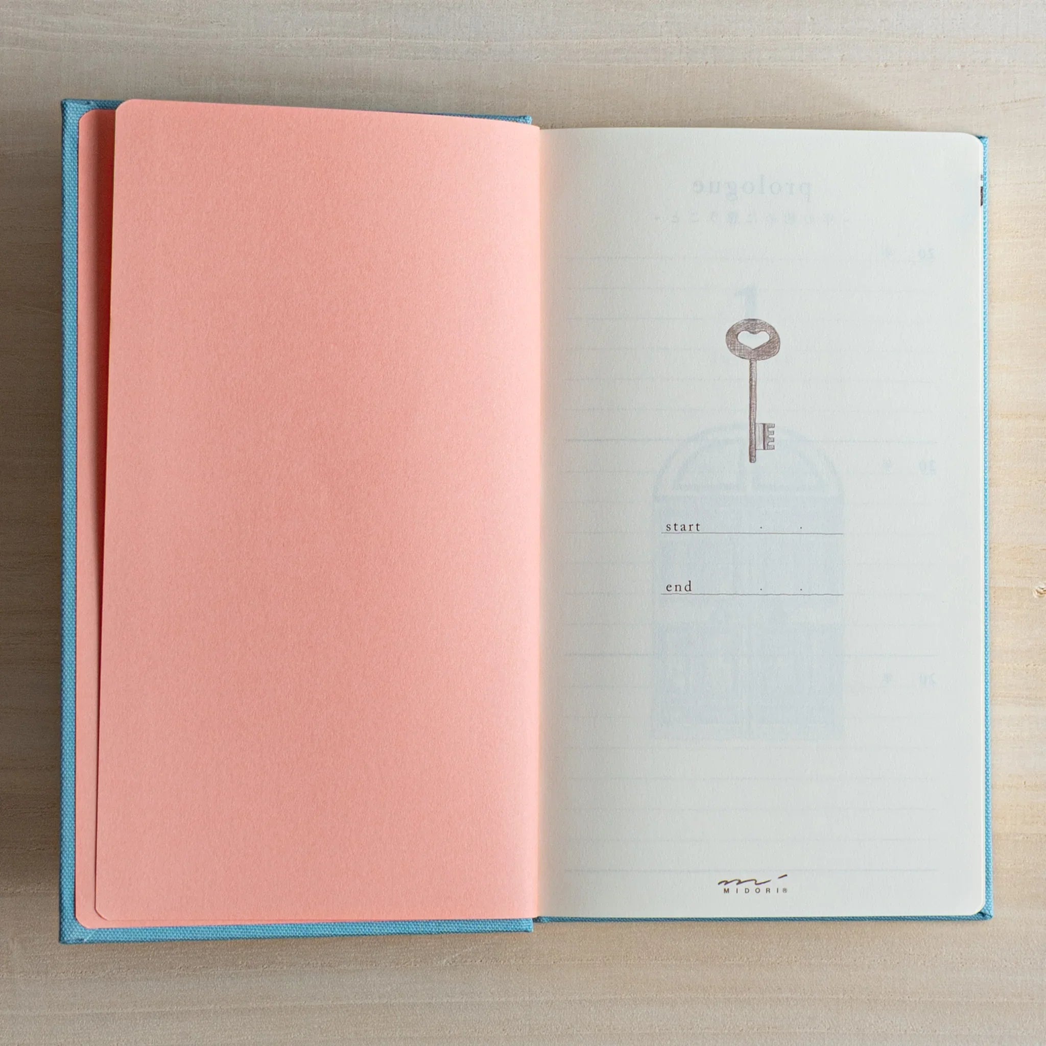 Open Midori Japanese journal 3 Year Diary Gate Design showing pink endpaper and key illustration start page.