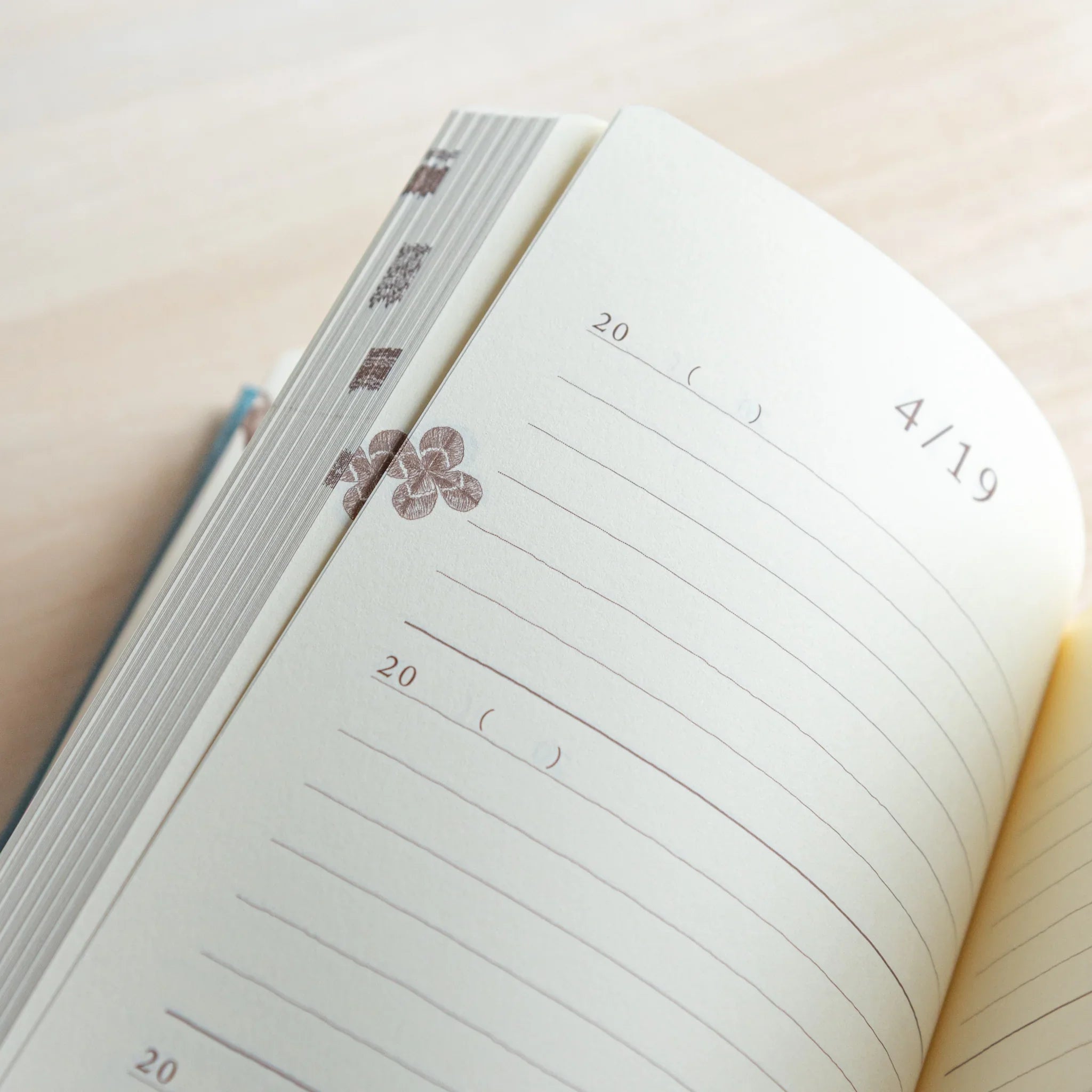 Midori 3-year journal, flat lay displaying open pages with date field, compact Midori 3-year dated hardcover notebook made in