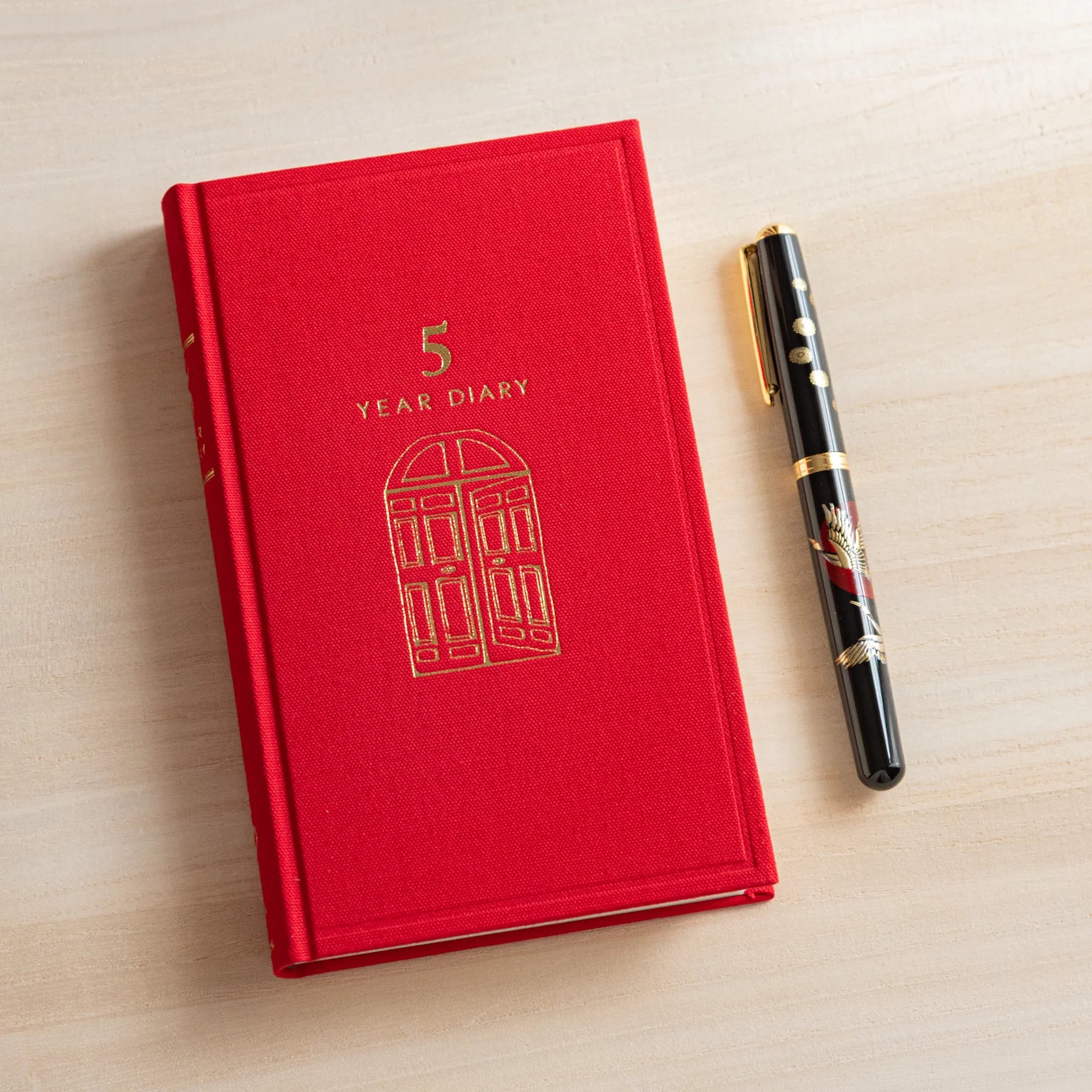 Midori 5-year journal, open spread showing cream interior with date headers, Japanese stationery product with quality