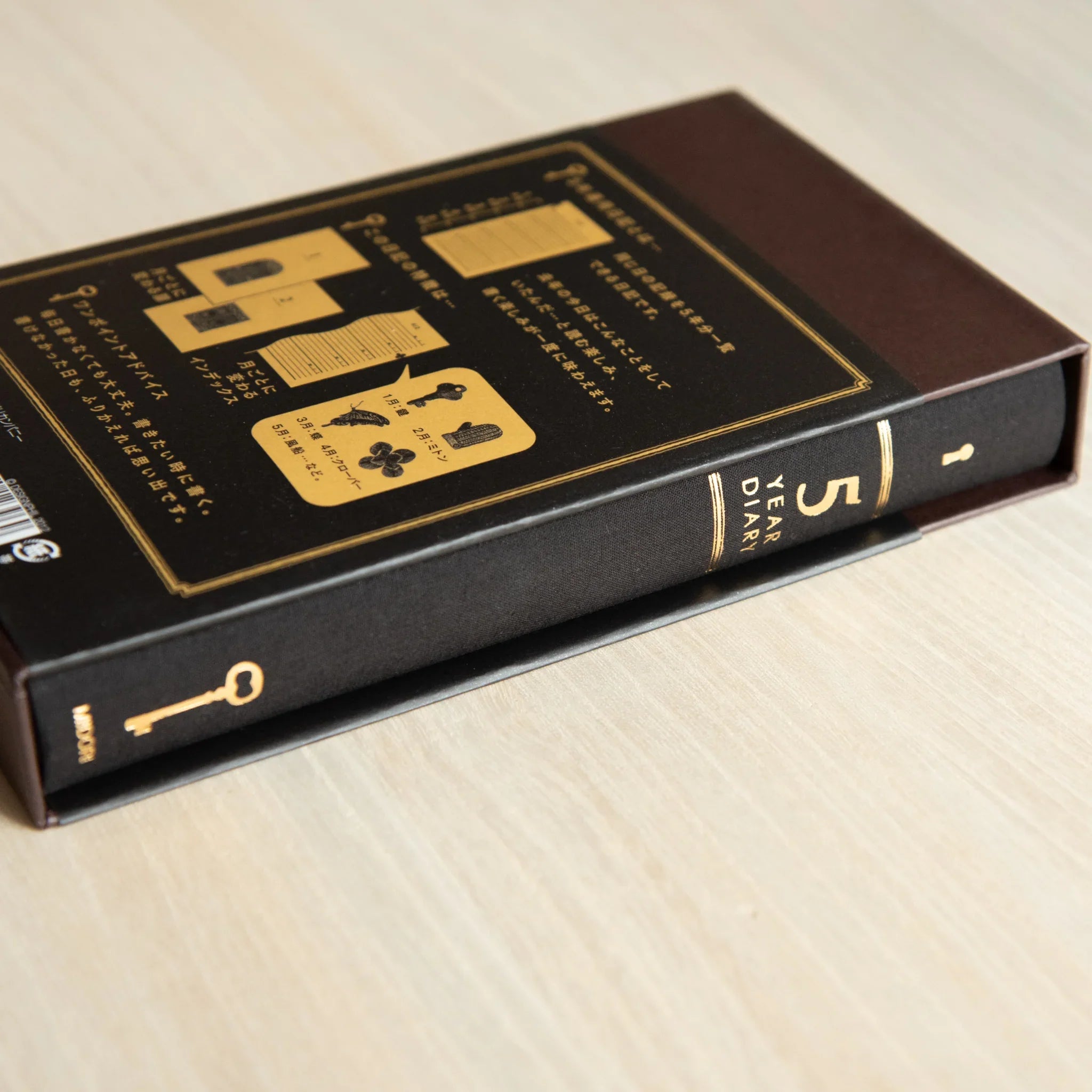 Midori 5-year journal, angled view displaying open pages and gate design cover, Japanese stationery product with quality