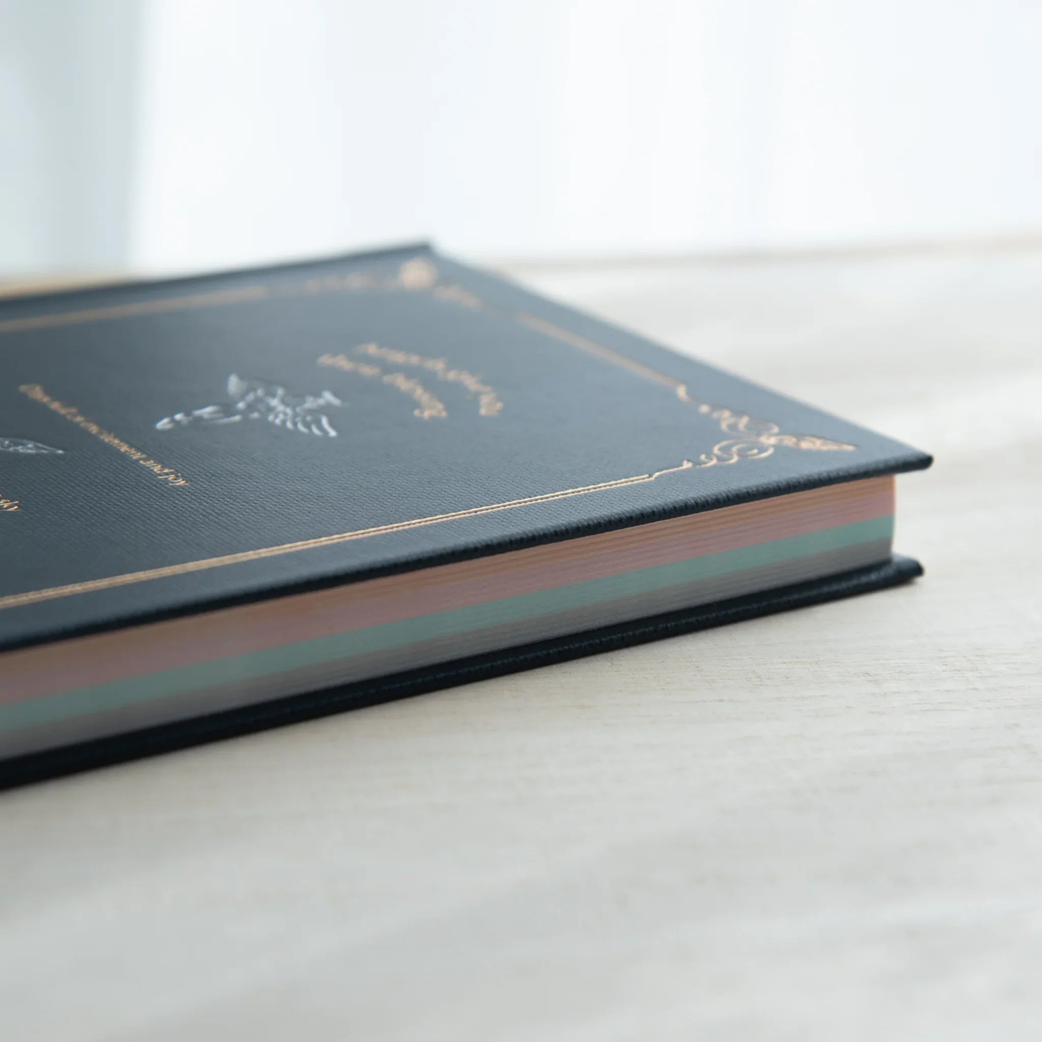 Interior double-page spread with light blue watermarked angel motifs and ruled horizontal writing lines visible clearly