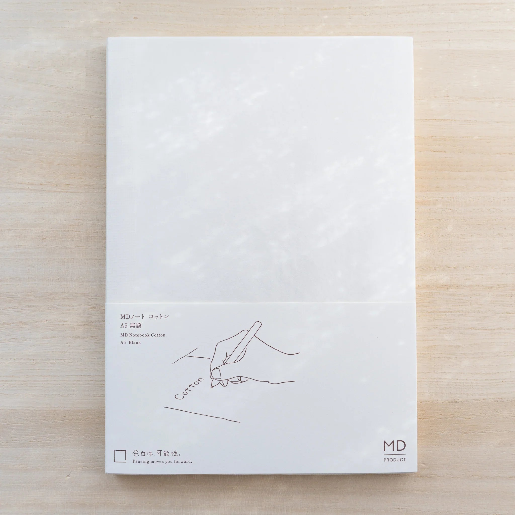 Midori MD Cotton Notebook A5, white cover with paper belly band reading MD Notebook Cotton A5 Blank and hand drawing