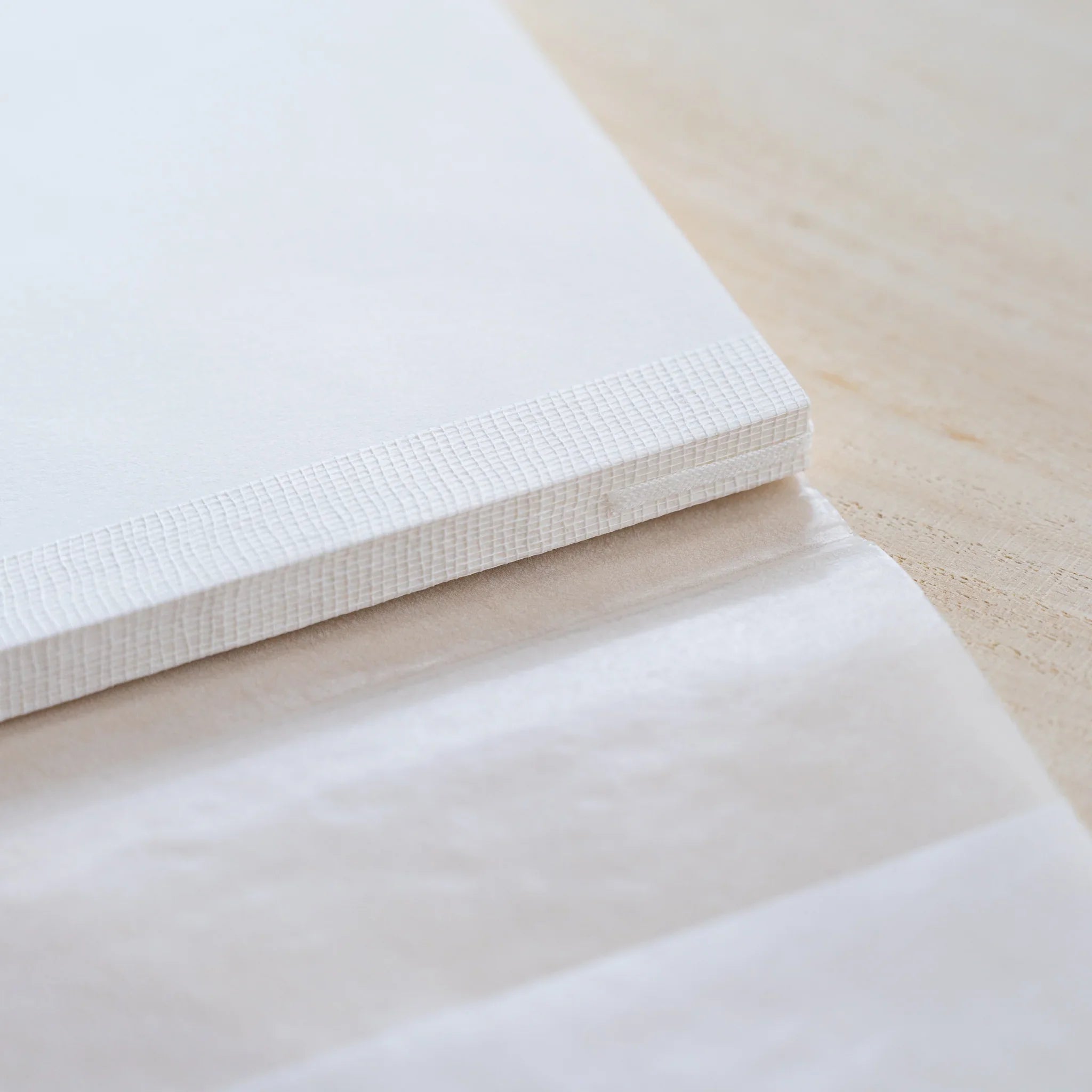 Close-up of the MD Cotton Notebook A5 Square edge and cream page block