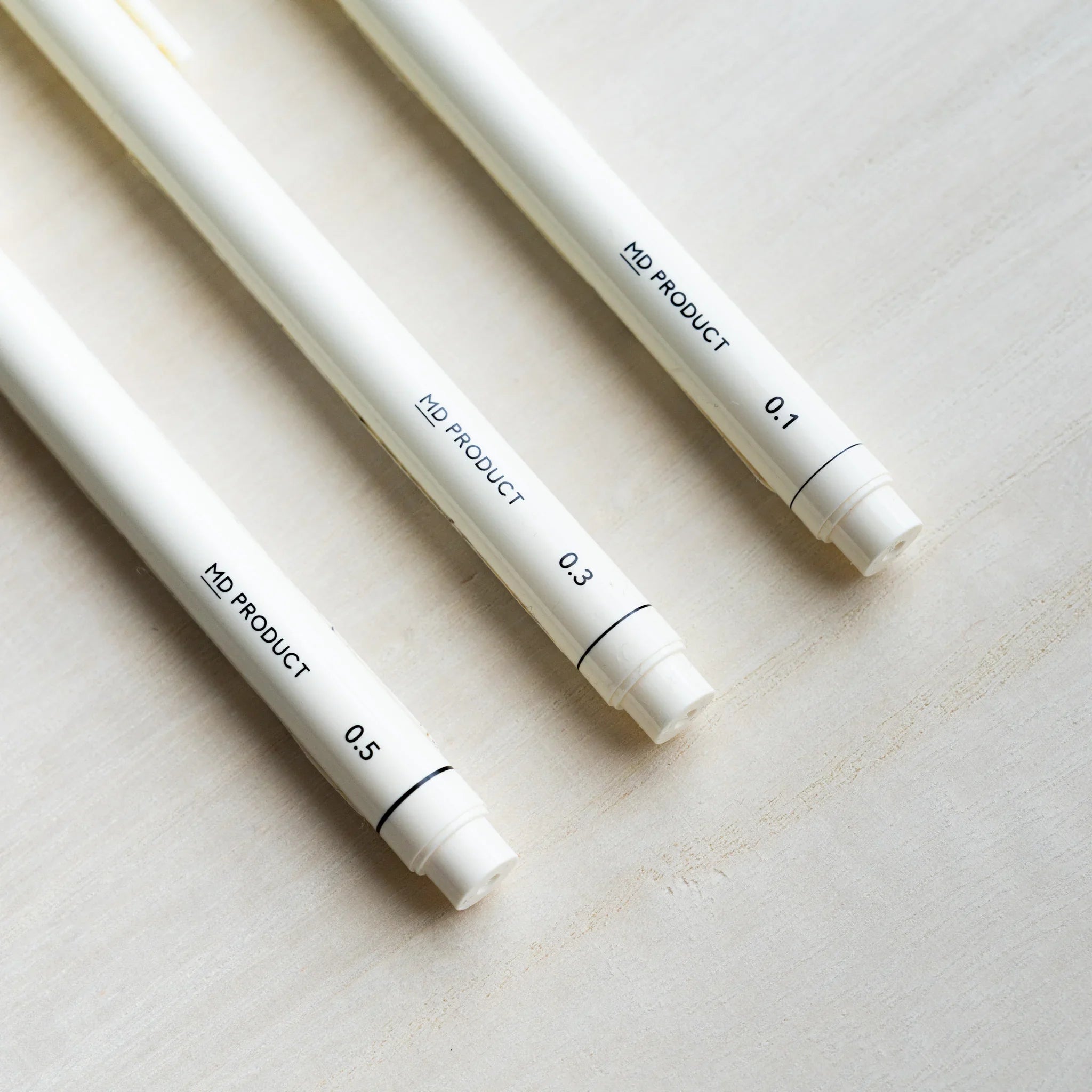 Angled view of Midori MD Drawing Pen barrels printed MD PRODUCT with 0.5, 0.3, and 0.1 mm size markings