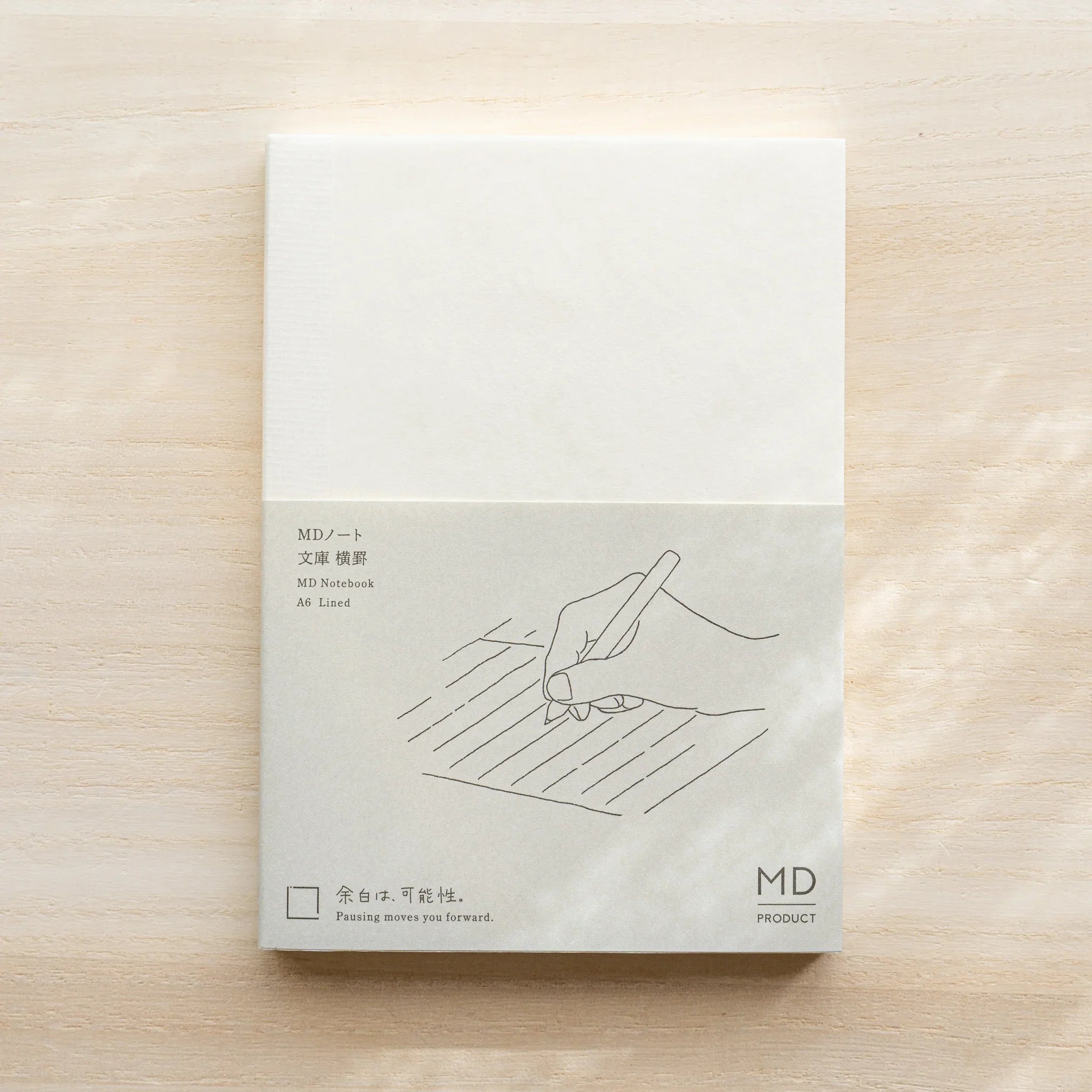 Midori MD Notebook A6 Lined front cover with glassine, gray lower half with hand writing on lined paper illustration, MD logo