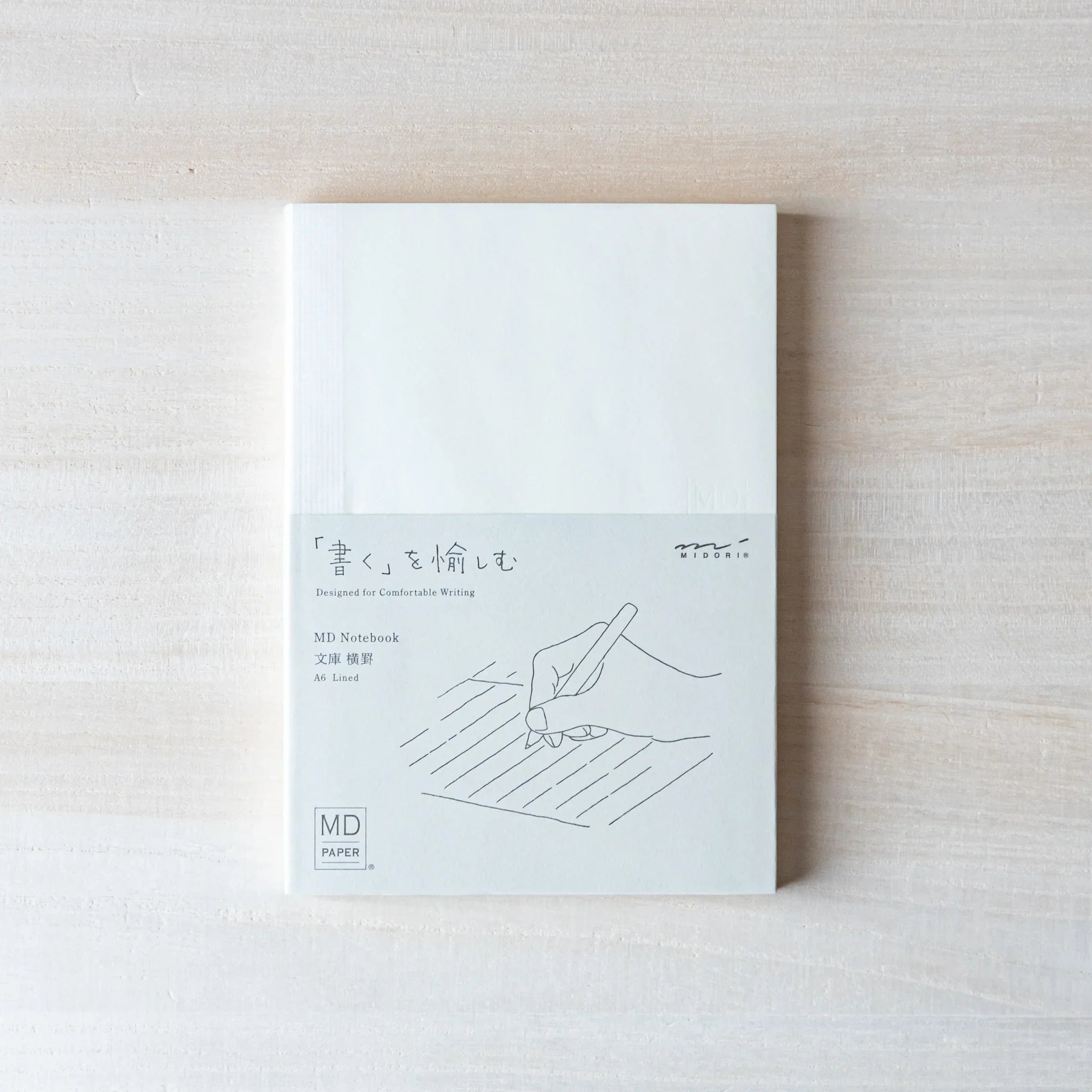 Japanese Notebook Midori MD A6 front cover with minimalist illustration.