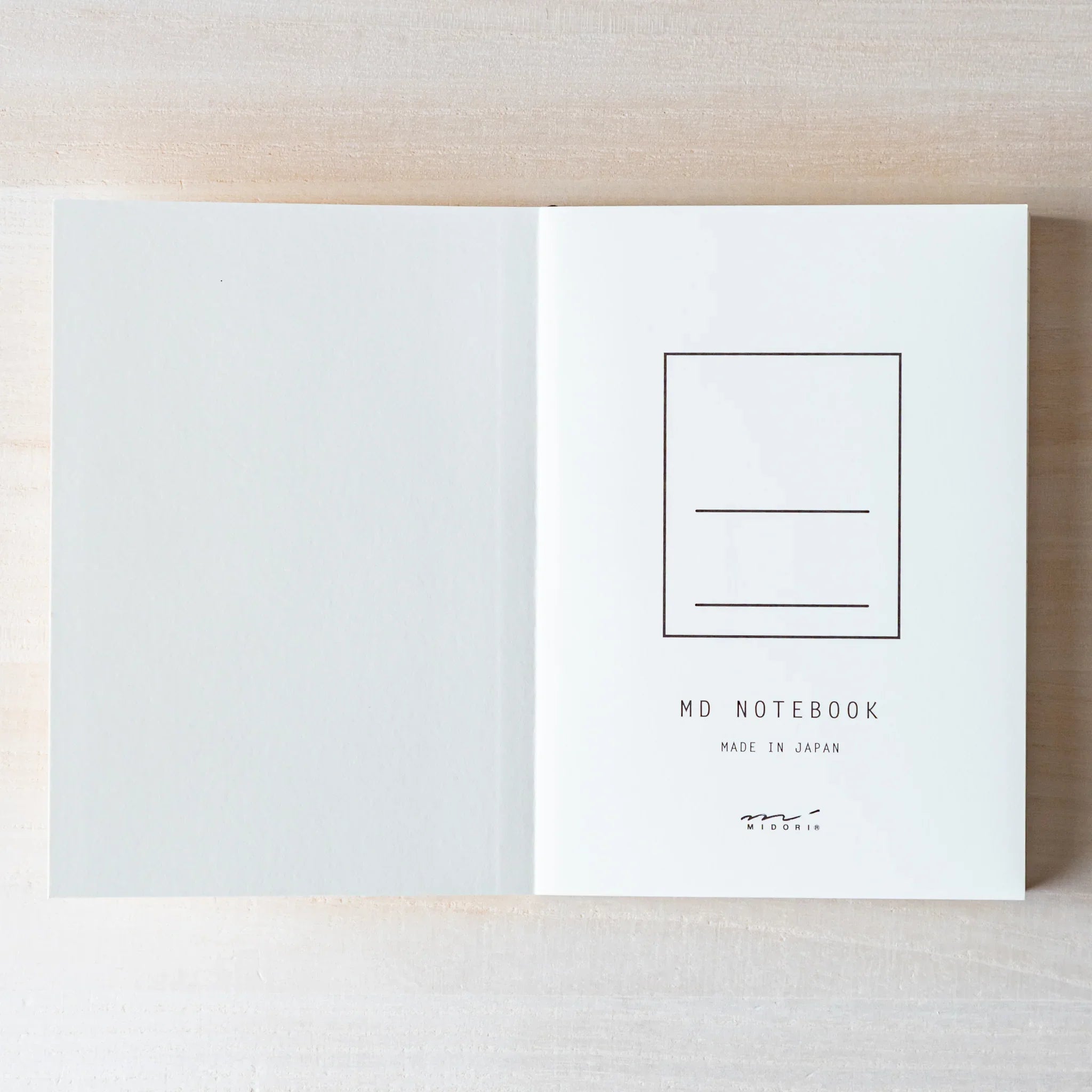 Japanese Notebook Midori MD A6 opened flat with MD NOTEBOOK design.