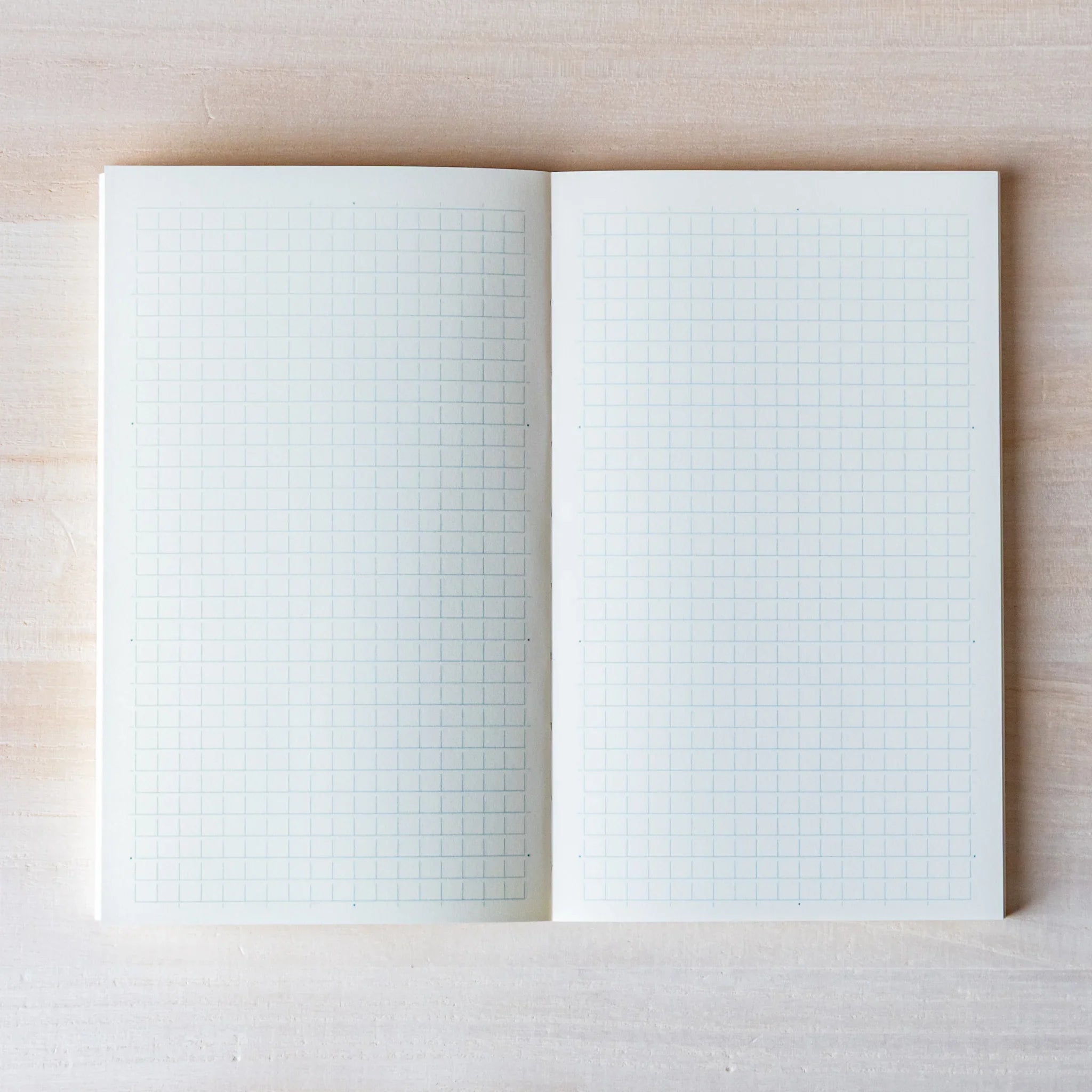 Midori MD B6 notebook, angled composition highlighting paper quality, Japanese MD notebook with fountain pen-friendly cream