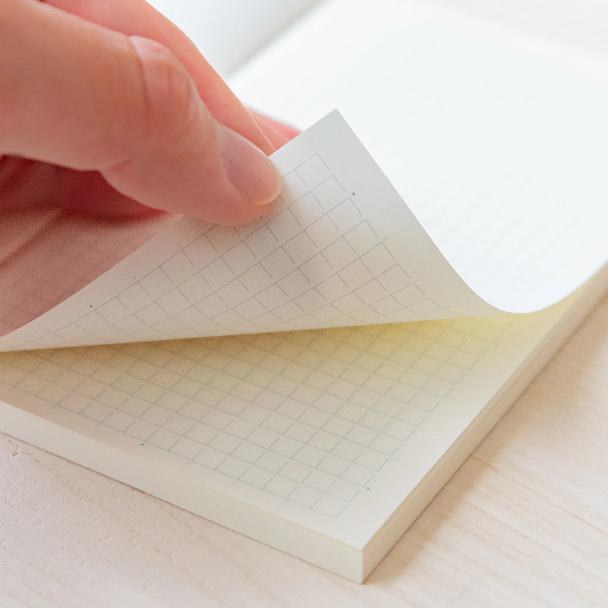 Midori MD B6 notebook, spine showing binding and B6 dimension, MD Notebook from Midori with thick cream paper and plain,