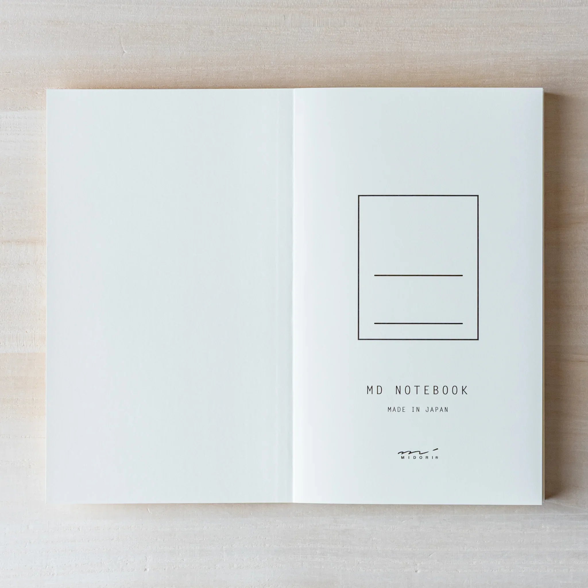 Japanese Notebook open: Midori MD B6 notebook laid flat, showing creamy paper with pages that lie open naturally.