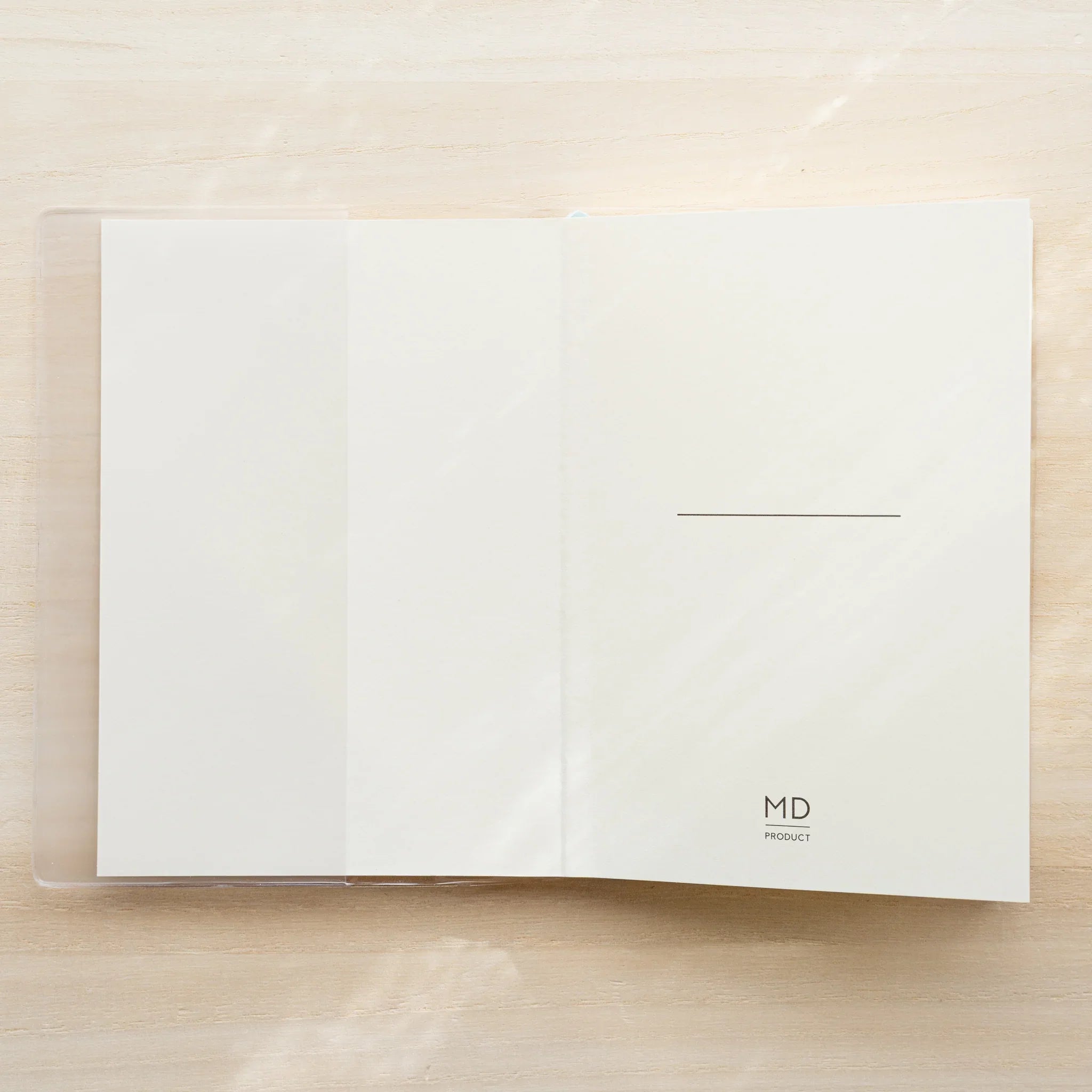 MD Notebook A5 Square open flat in clear PVC cover, white cover with center line and MD PRODUCT logo at bottom