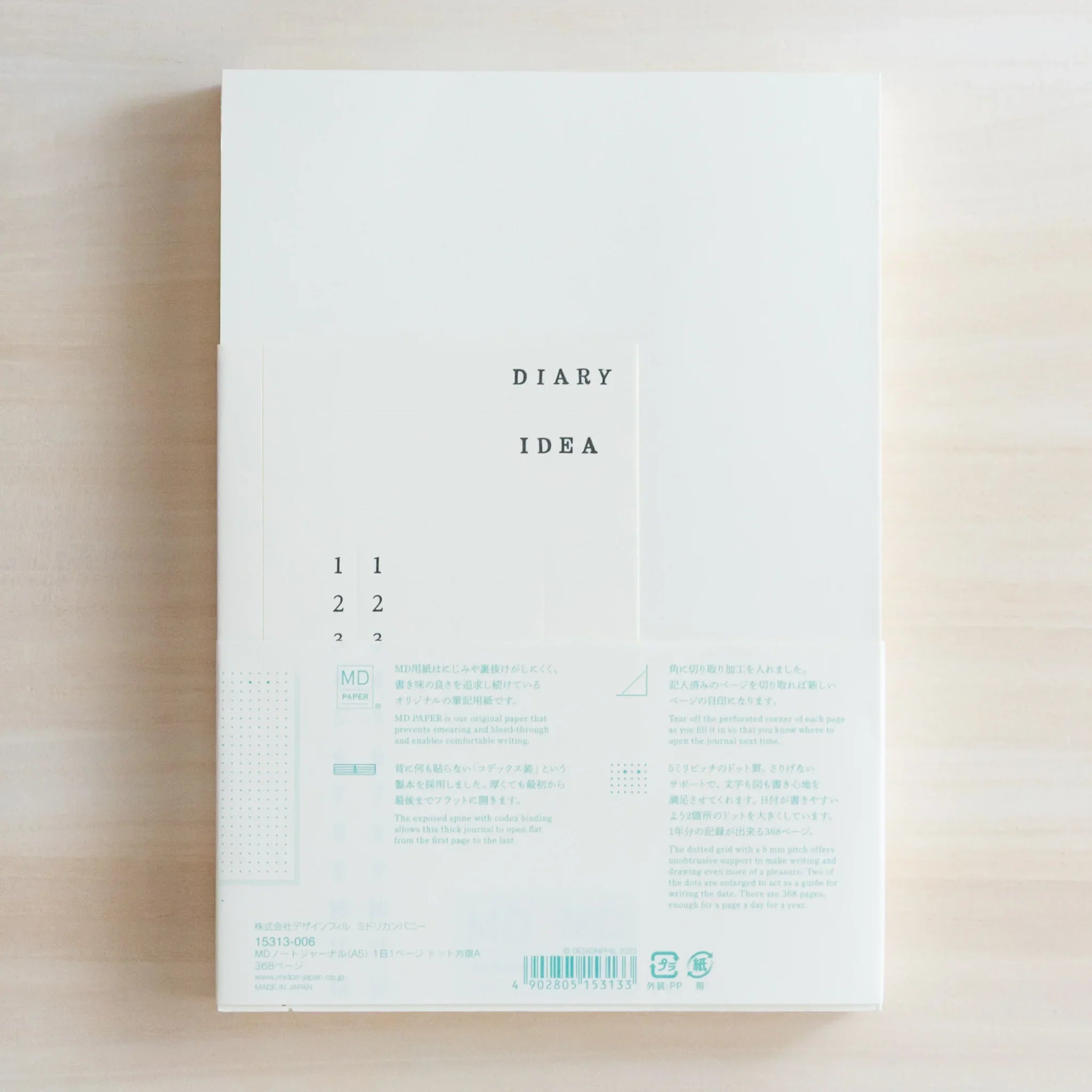 Top view of Midori Japanese journal packaging with DIARY IDEA label, numbers and text on cream background.