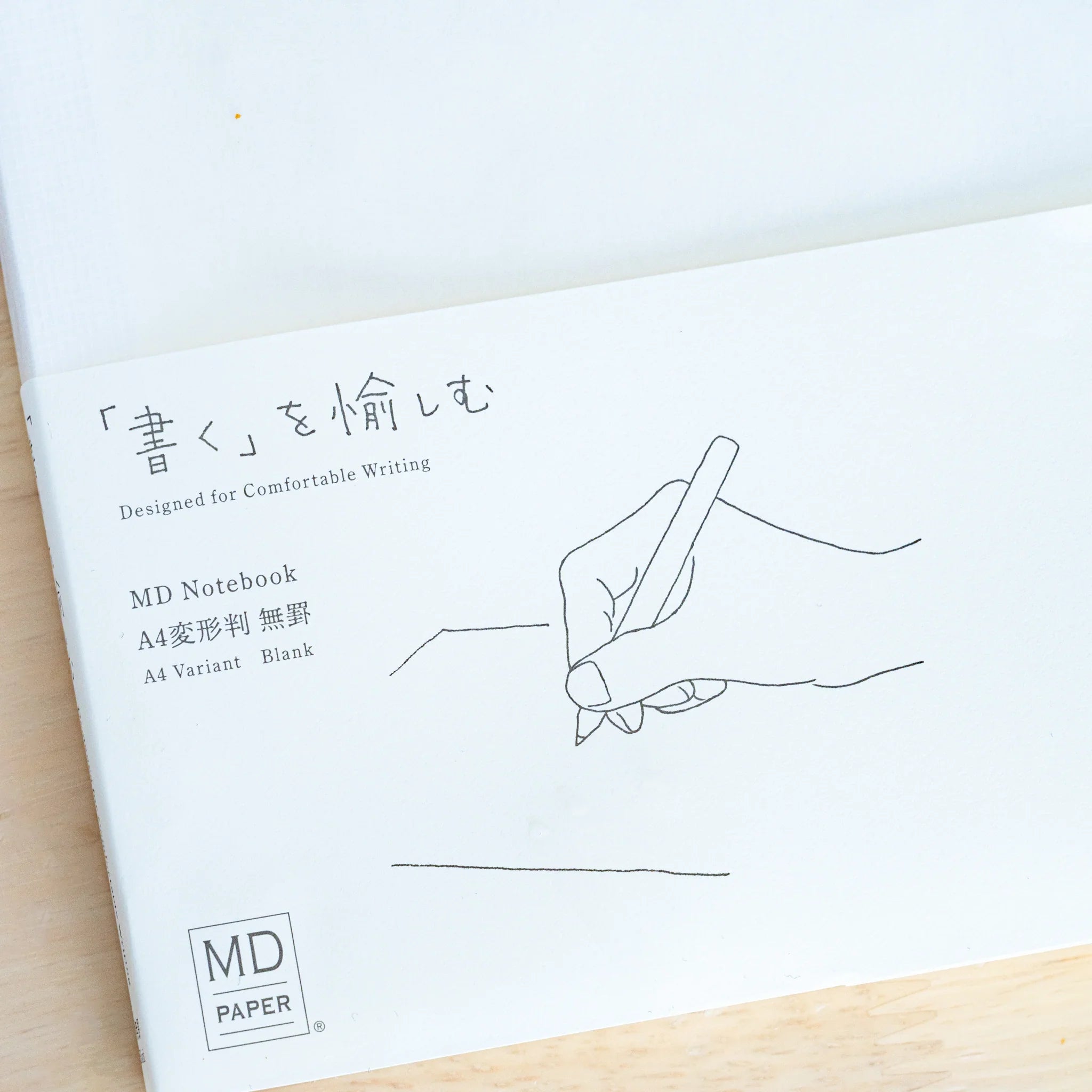 Midori MD A4 notebook, angled view showing open pages with visible lines, Japanese Midori MD notebook with cotton-smooth