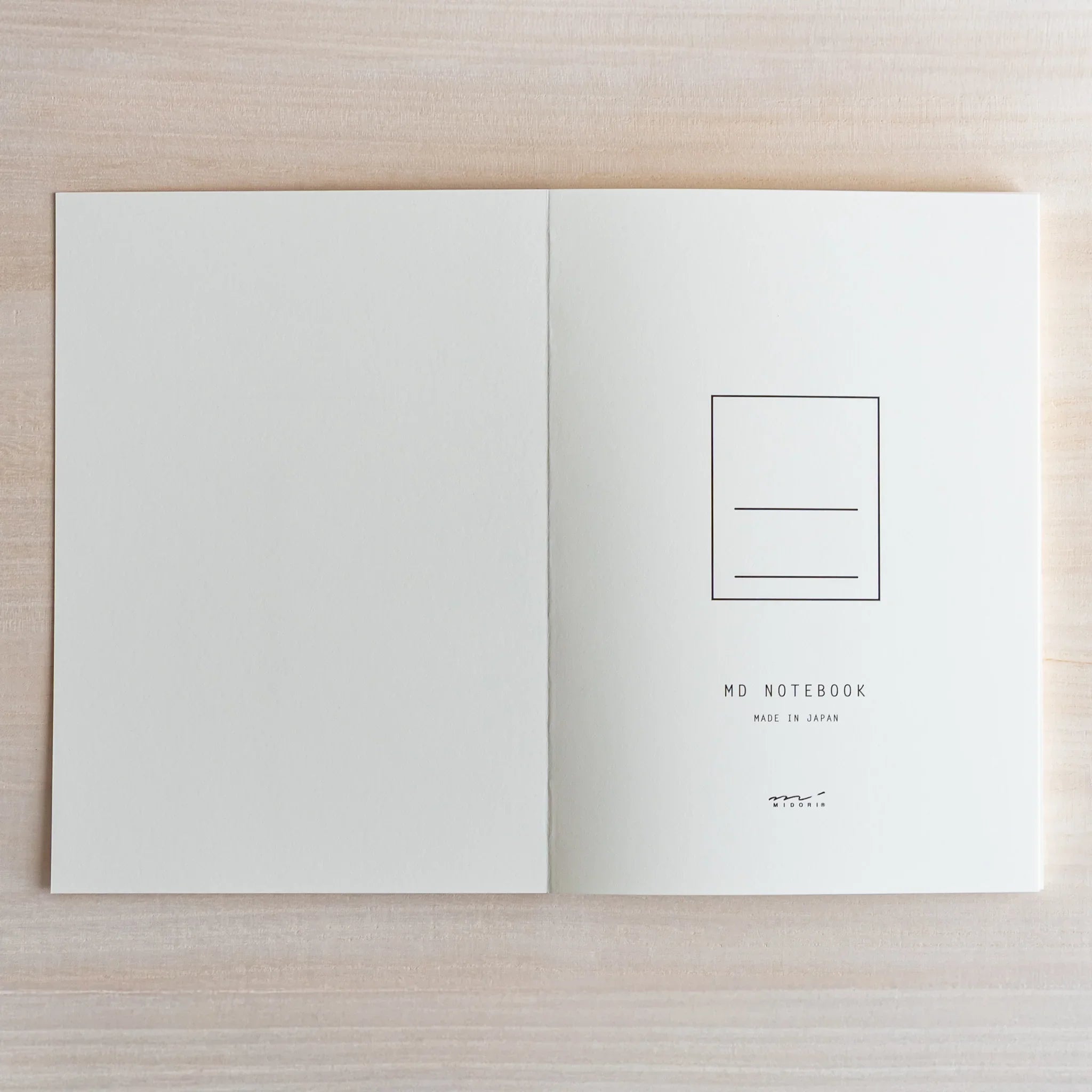 Midori MD A5 blank notebook, open spread showing blank cream paper quality, MD Notebook from Midori with thick cream paper