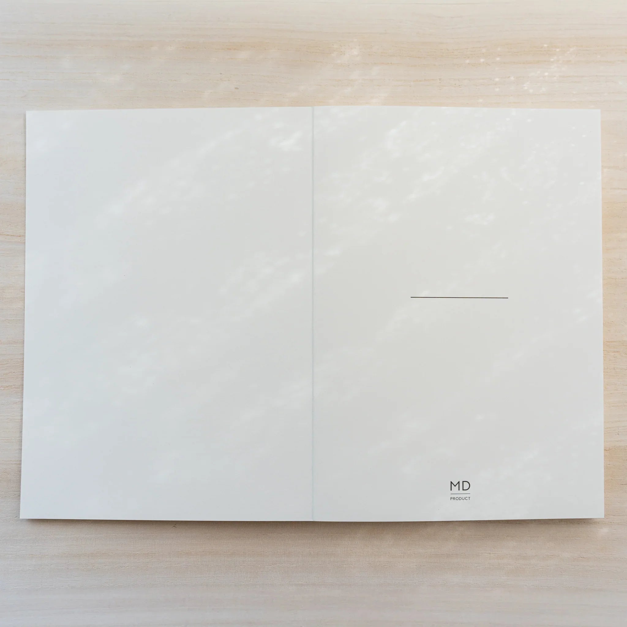 Midori MD Notebook Thick open flat to inside cover, blank cream pages with thin name line and small MD Product logo
