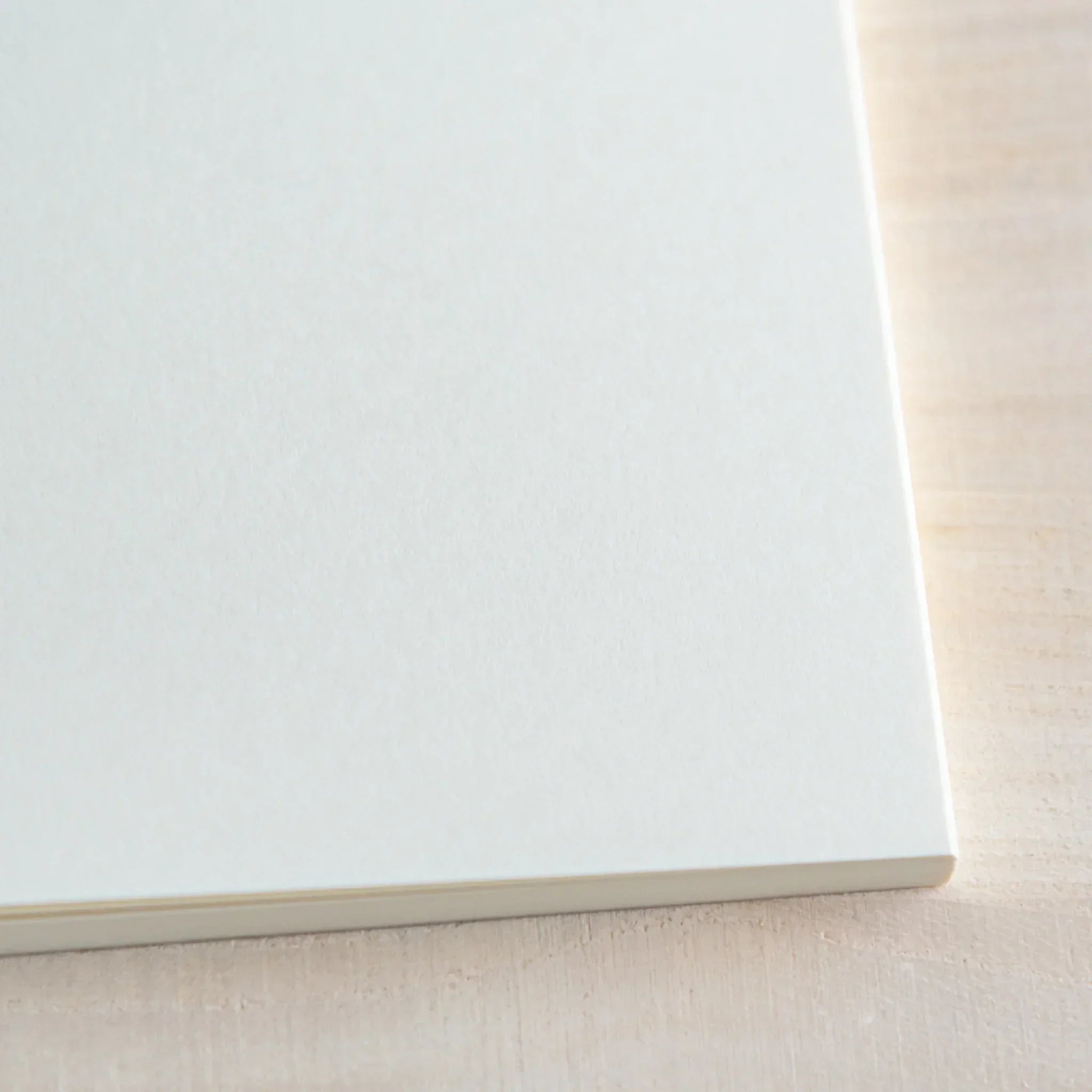 Midori MD A5 square grid notebook, side view showing A5 size binding, Japanese MD notebook with fountain pen-friendly cream