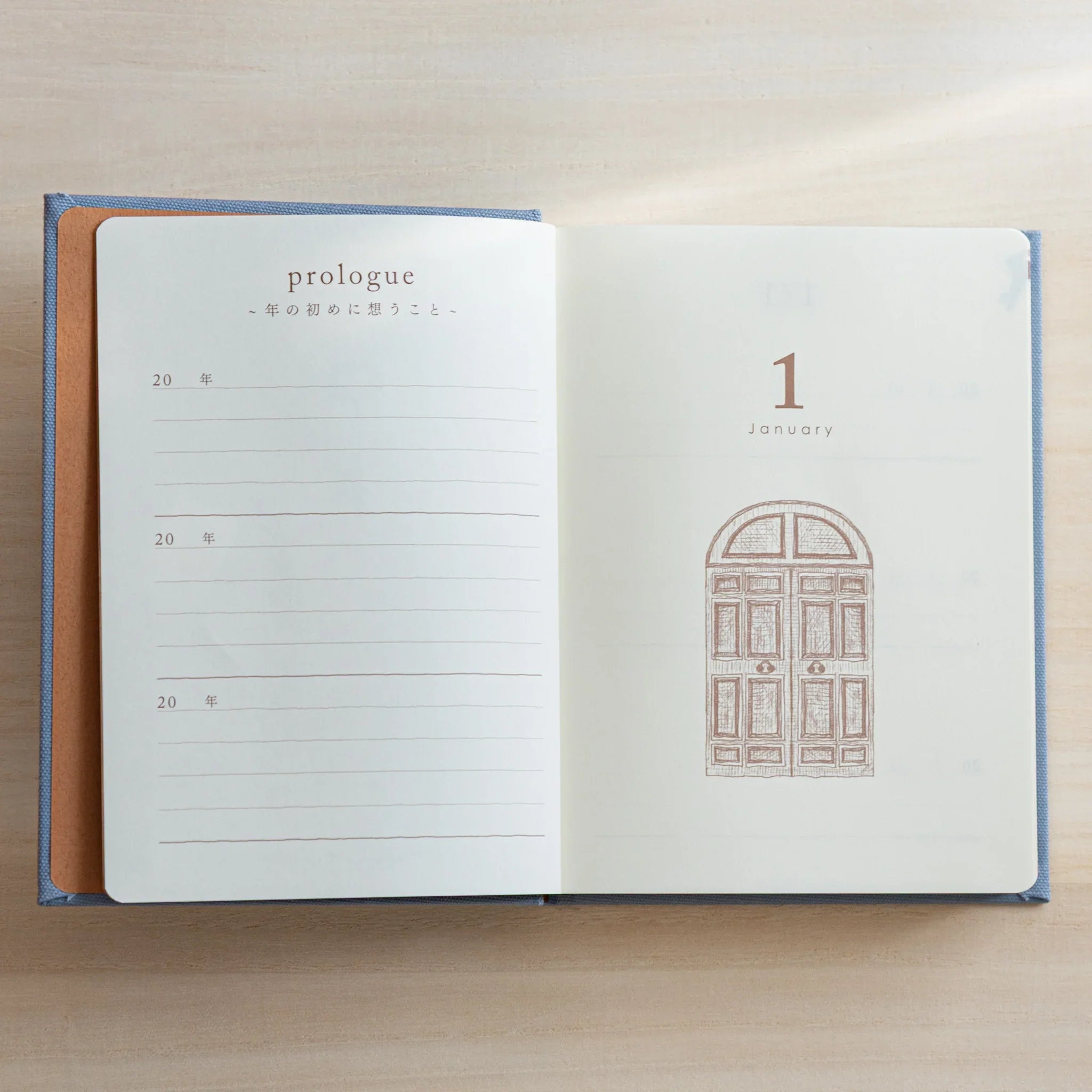 Japanese journal Midori 3-year diary open to prologue and January 1 spread with lines and gate illustration