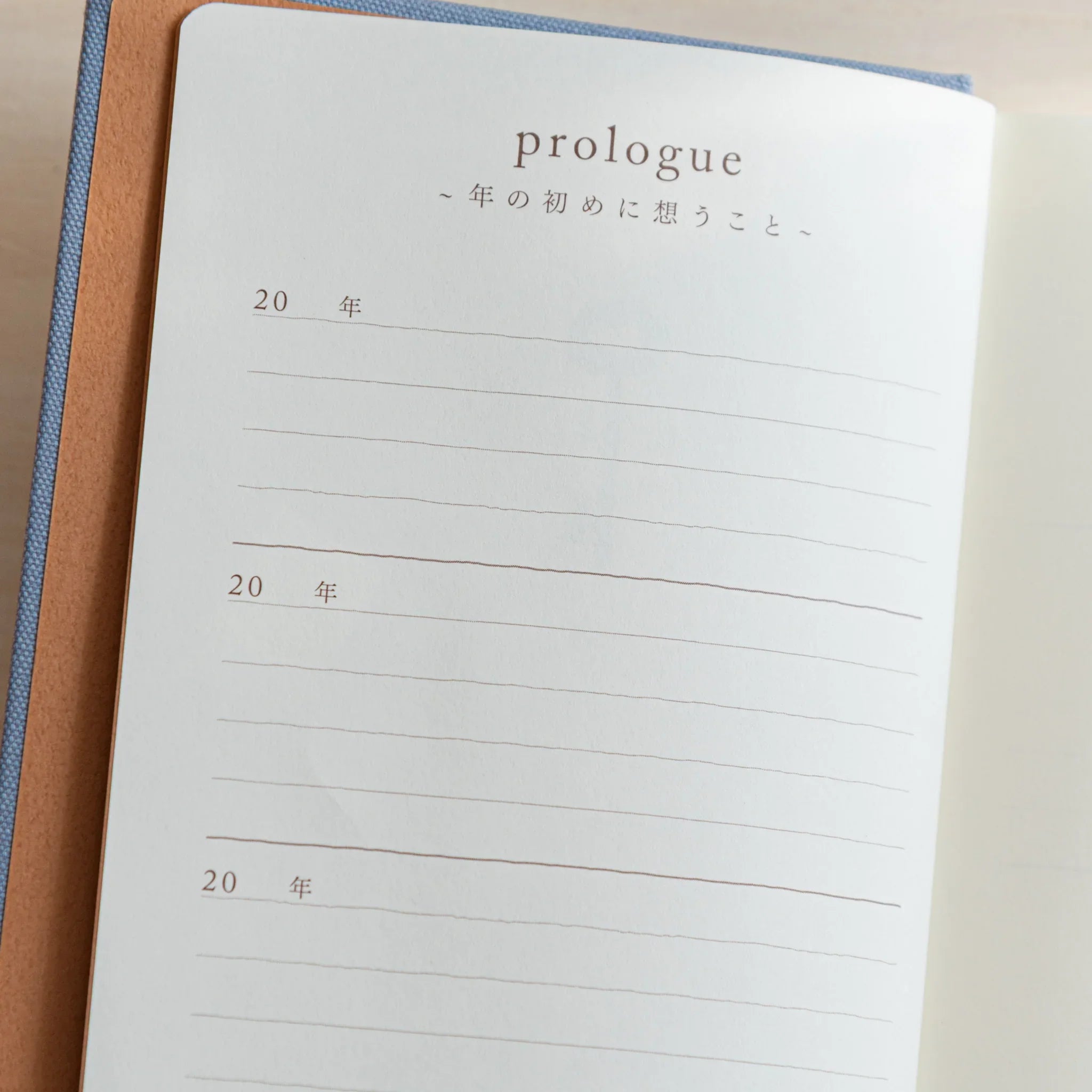 Open Midori Mini 3 Year Journal showing the “Prologue” page with lined sections and elegant Japanese text in gentle light.