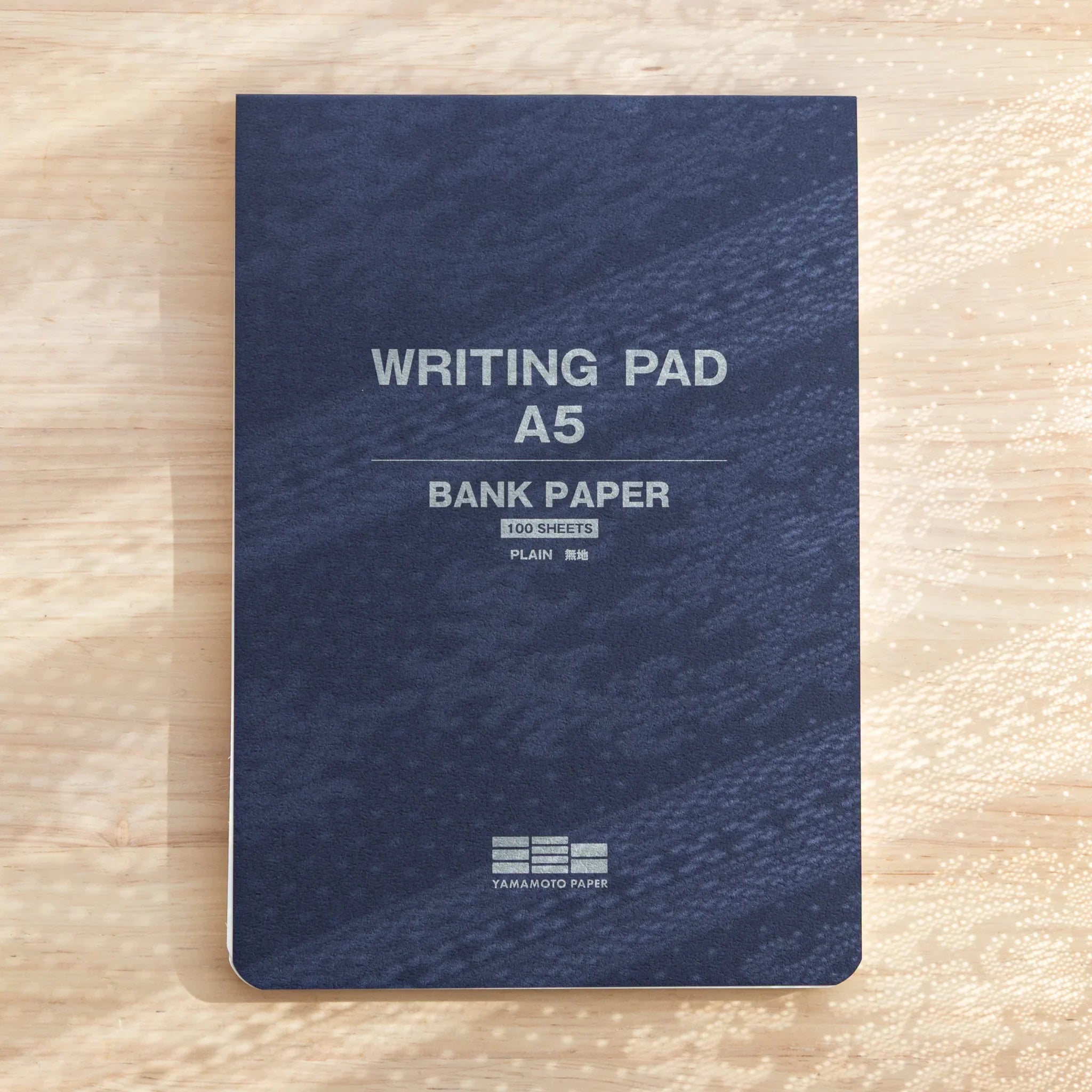 Mitsubishi Bank Ledger A5 writing pad showing navy blue cover with white text and Yamamoto Paper branding