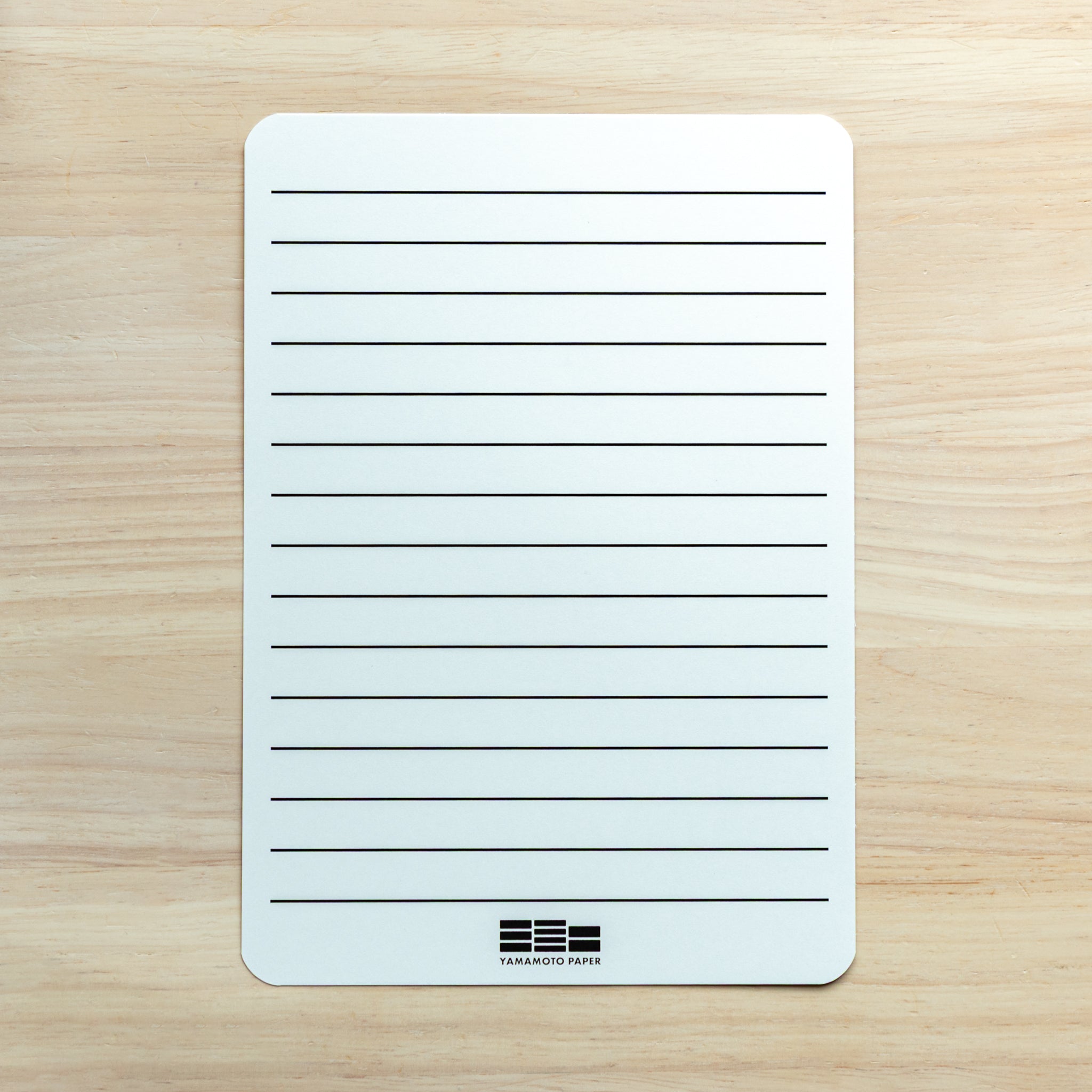 Accessory sheet with horizontal lines included in Sanzen Tomoe River A5 Japanese Writing Pad for neat handwriting.